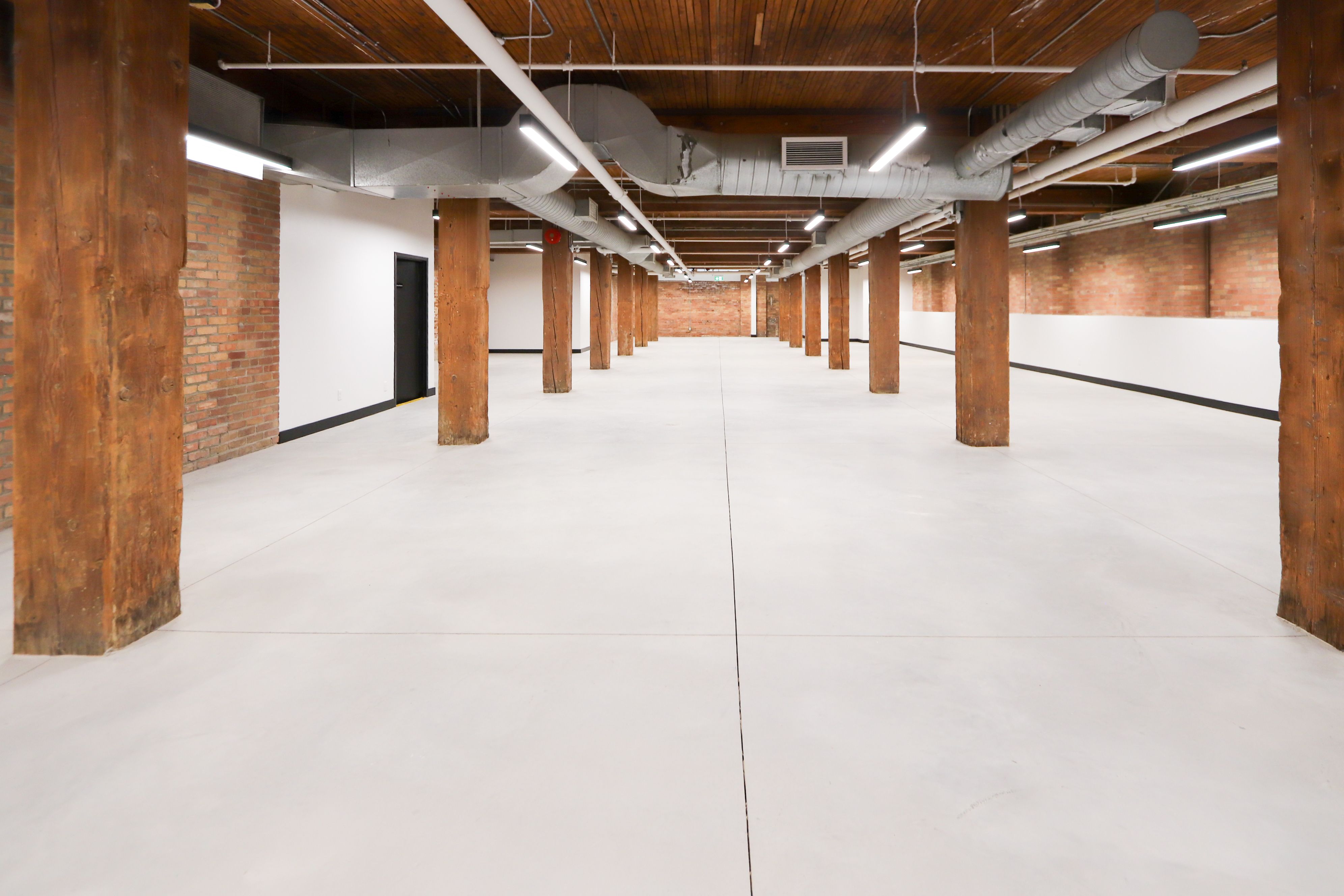 Empty loft floor with rows of wood columns