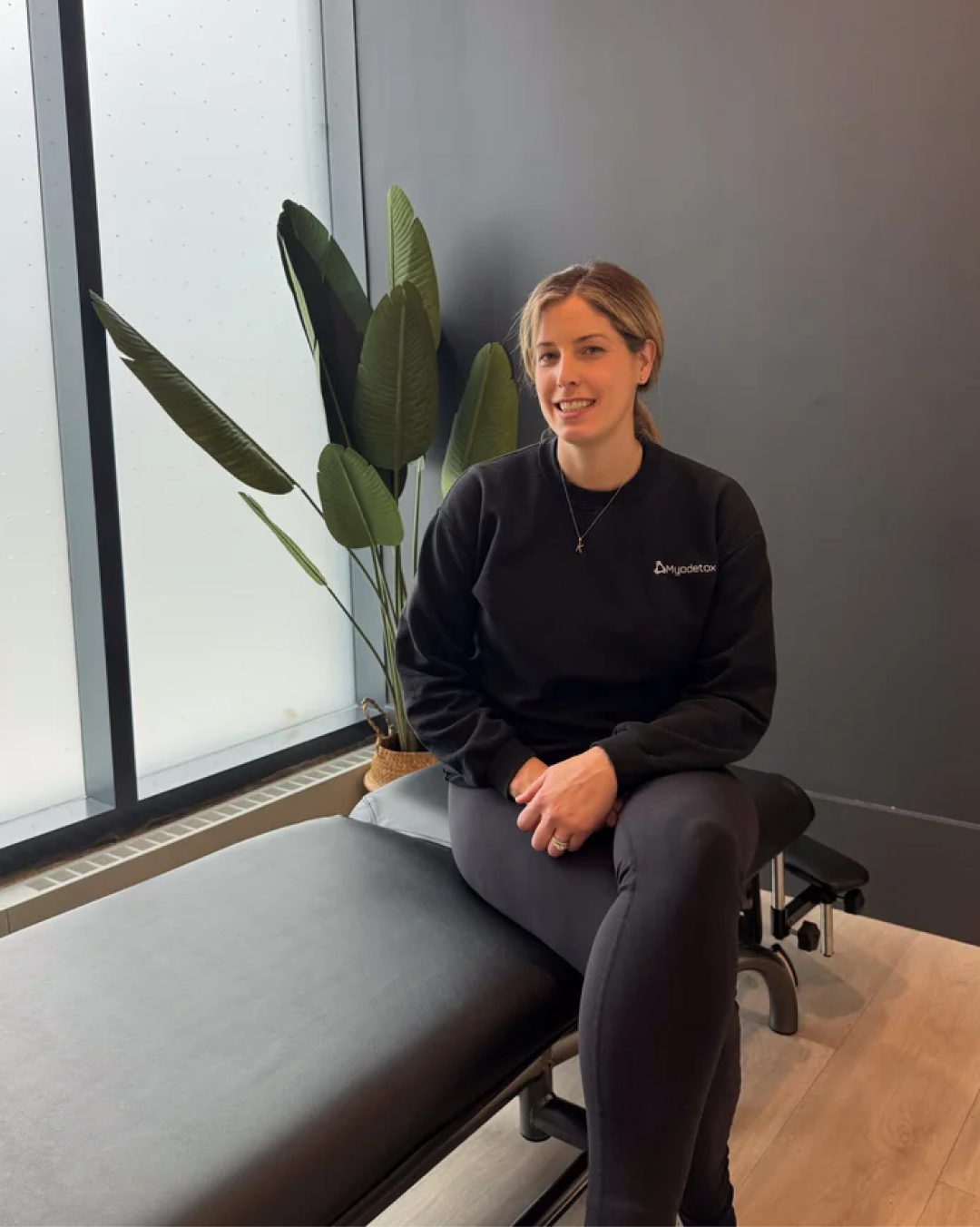 Myodetox practitioner on a treatment table