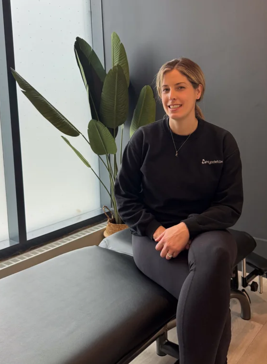 Myodetox practitioner on a treatment table