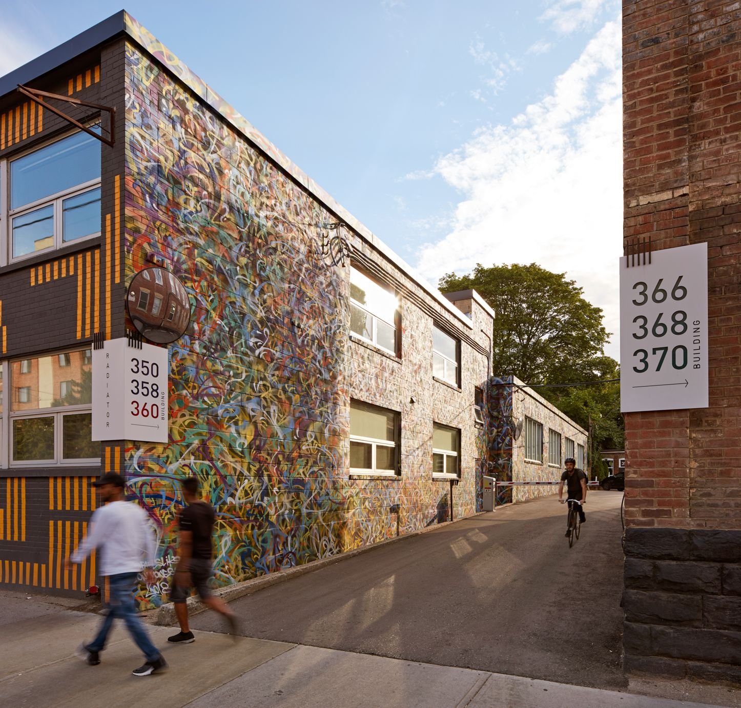 Graffiti-covered warehouse wall along a laneway