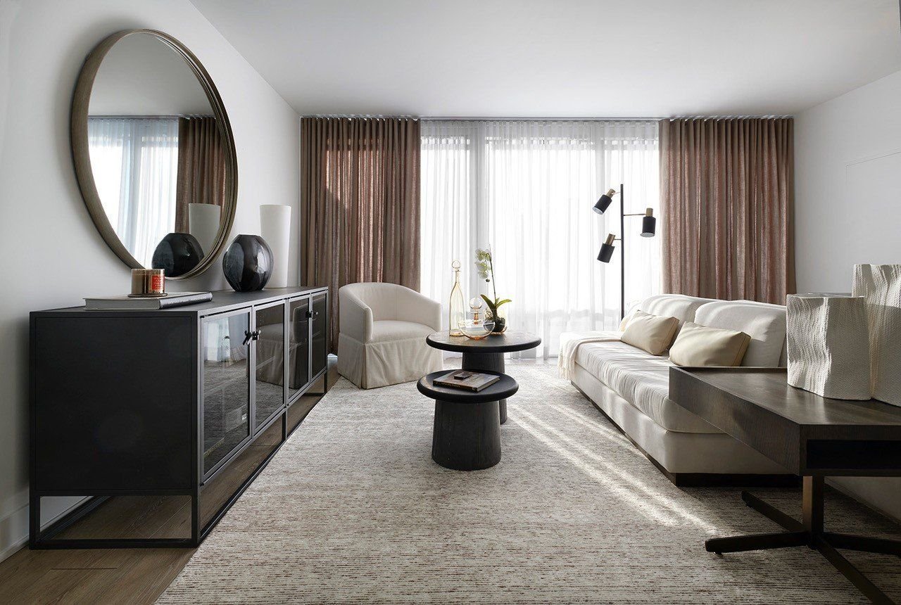 Living room with round mirror and pale sofa