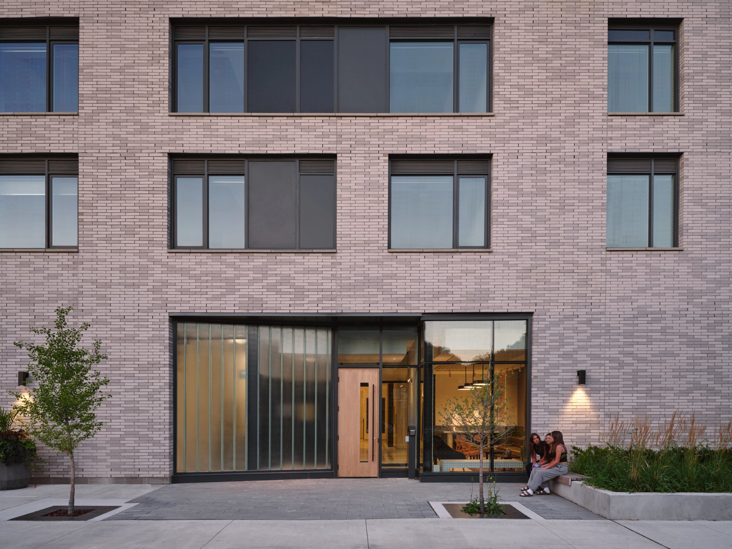 Pale brick facade with glazed entry