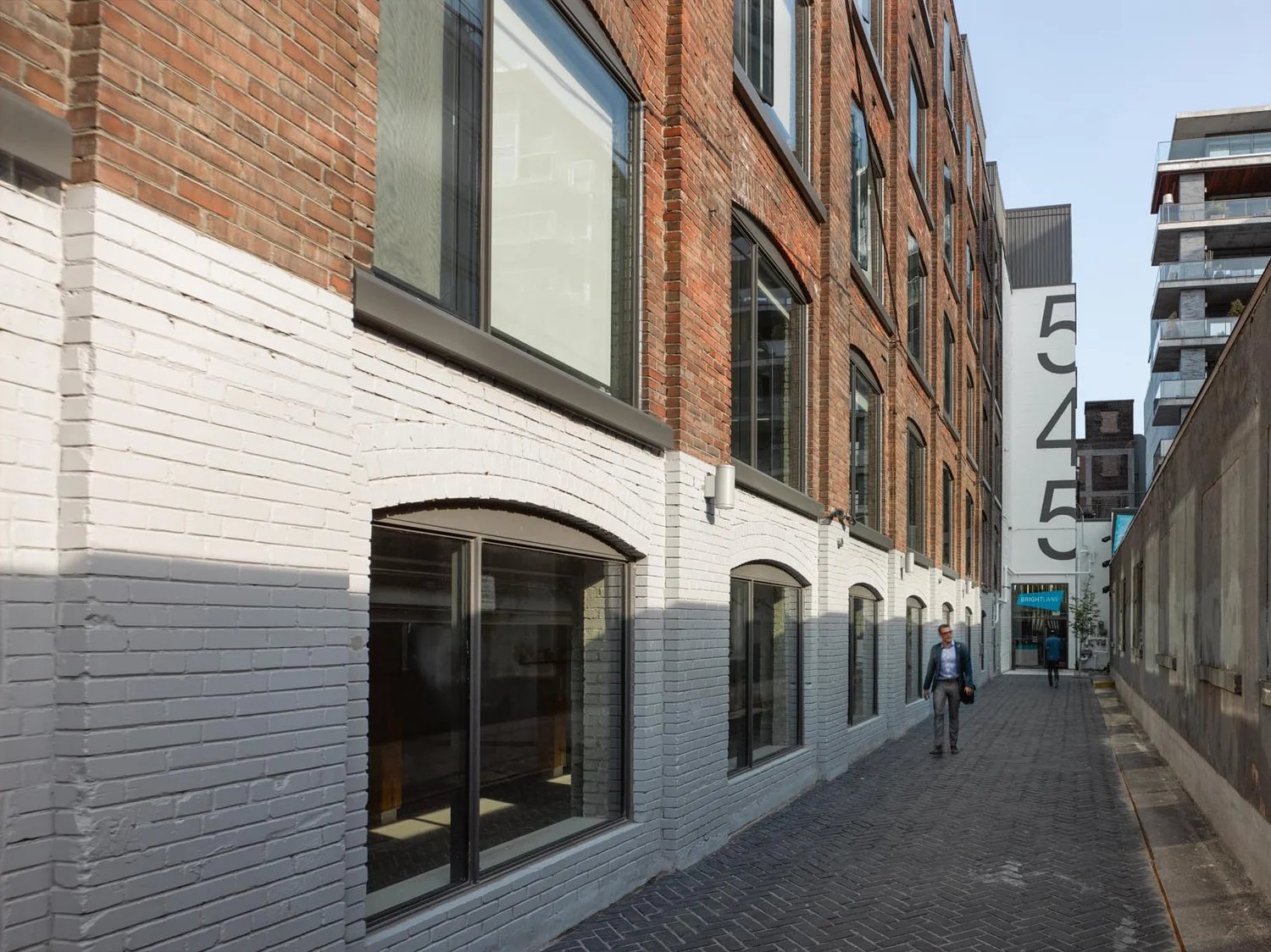 Brick and painted-brick lofts on a laneway