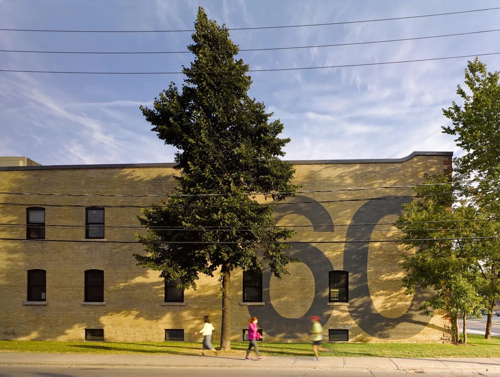 Brick wall with a large painted number 60