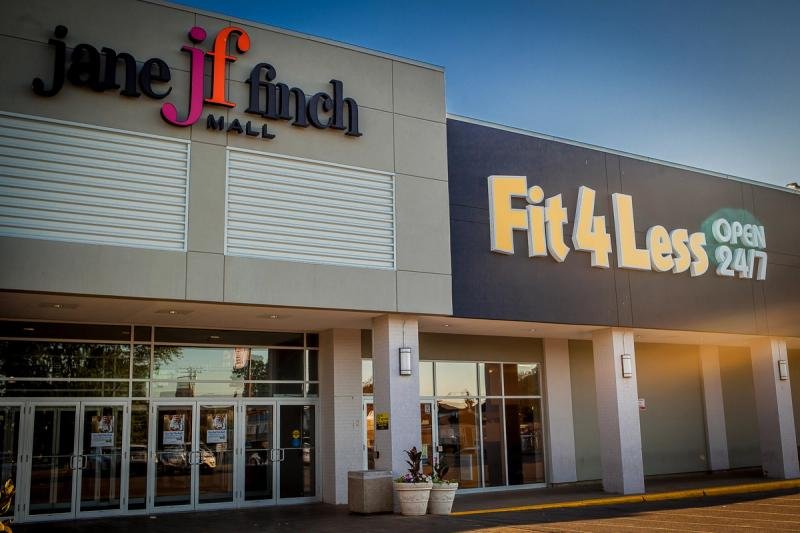 Mall entrance with lit storefront signage