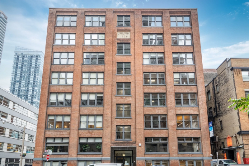 Red brick loft office building on a city street