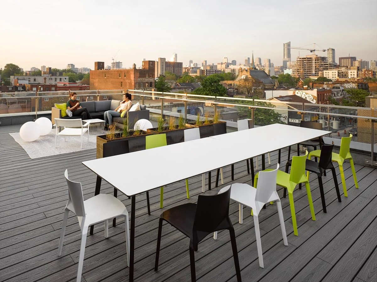 Roof deck with long table and city skyline