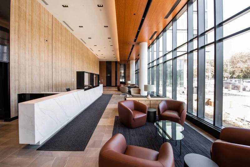 Office lobby with stone desk and leather chairs