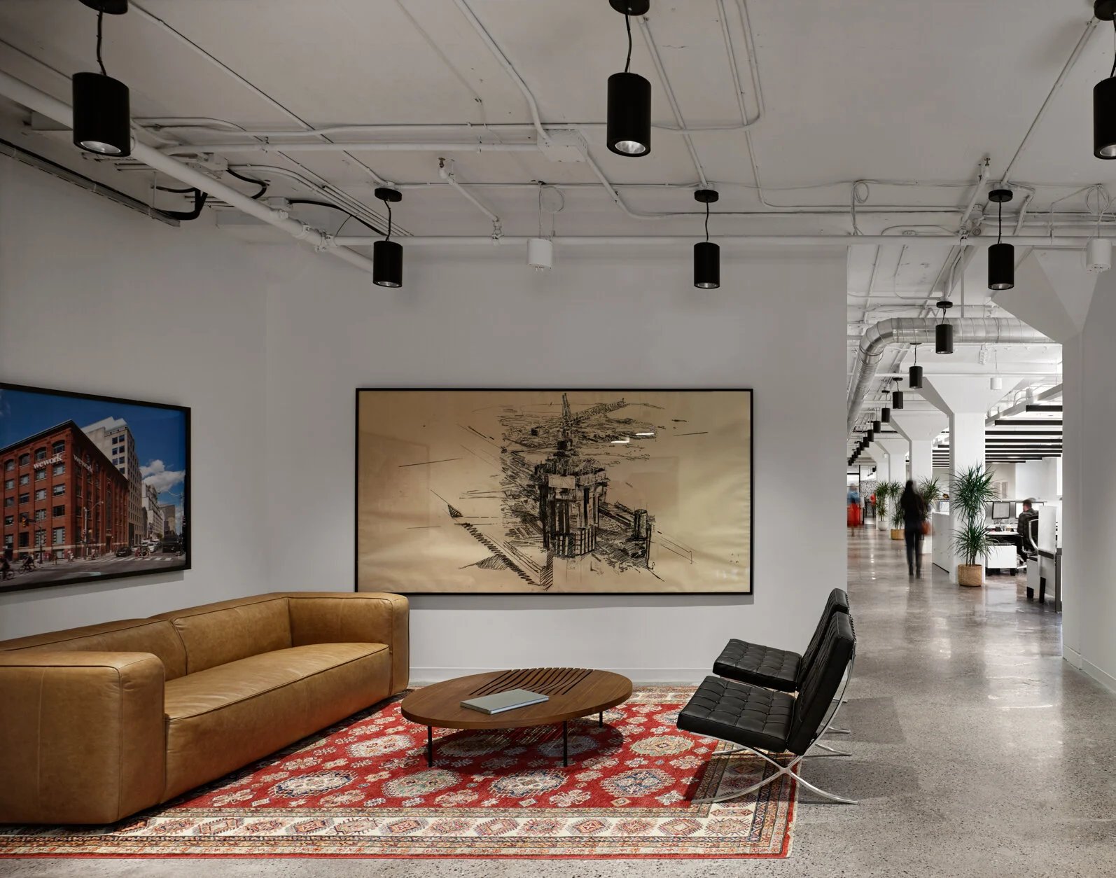 Office lounge with leather sofa and artwork