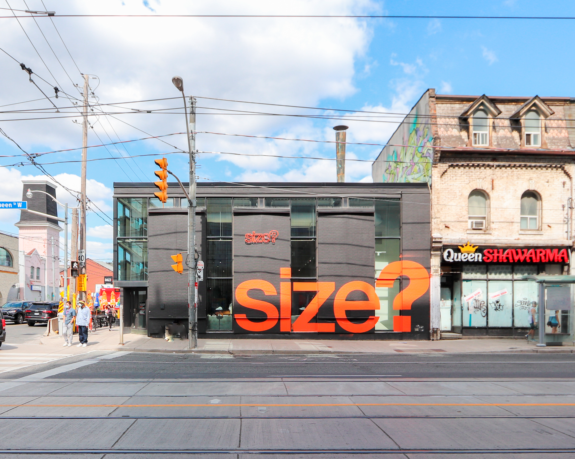 Black storefront with large orange signage