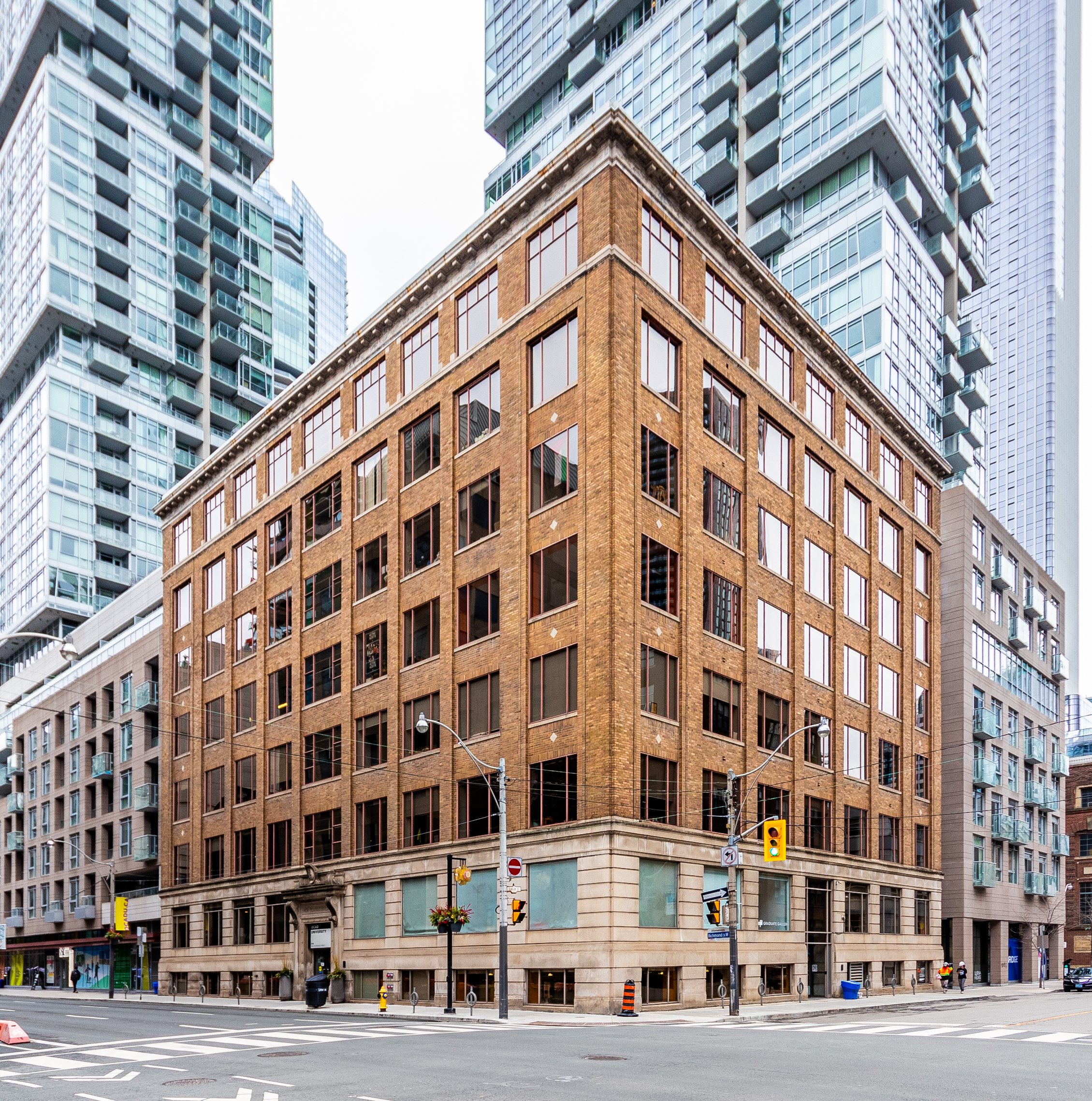 Corner brick warehouse among glass towers