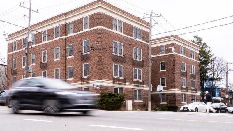Four-storey brick apartment on a busy road