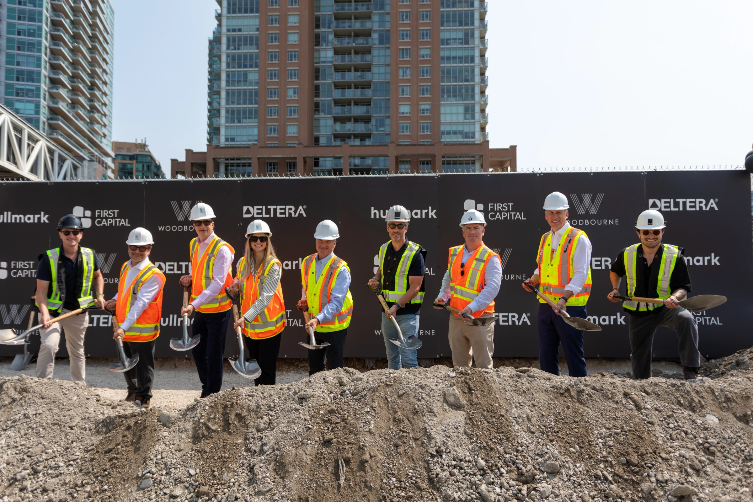 Nine people with shovels at a groundbreaking