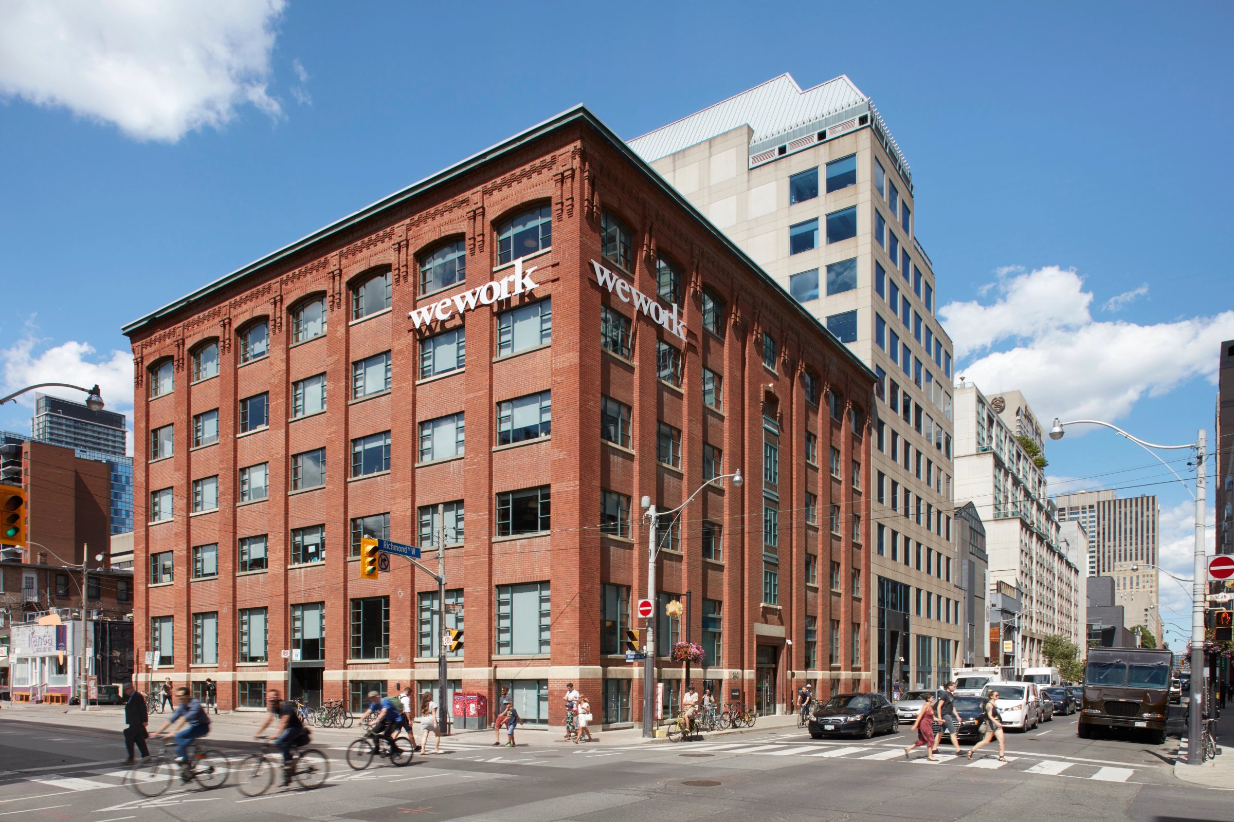 Six-storey brick building at a busy intersection