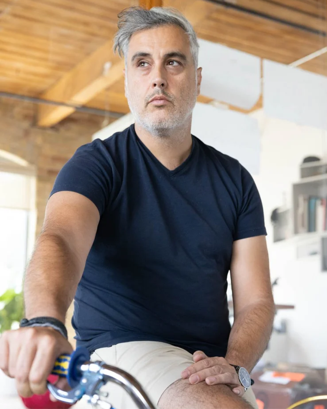 Person on a bicycle in a timber-beamed office