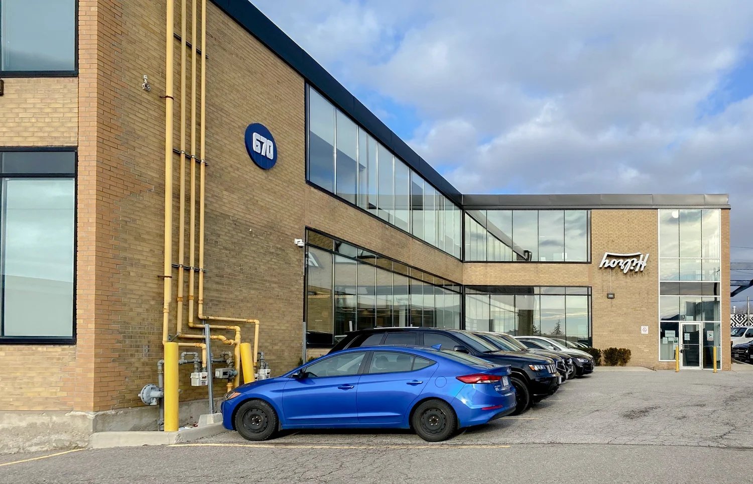 Brick office building with parked cars
