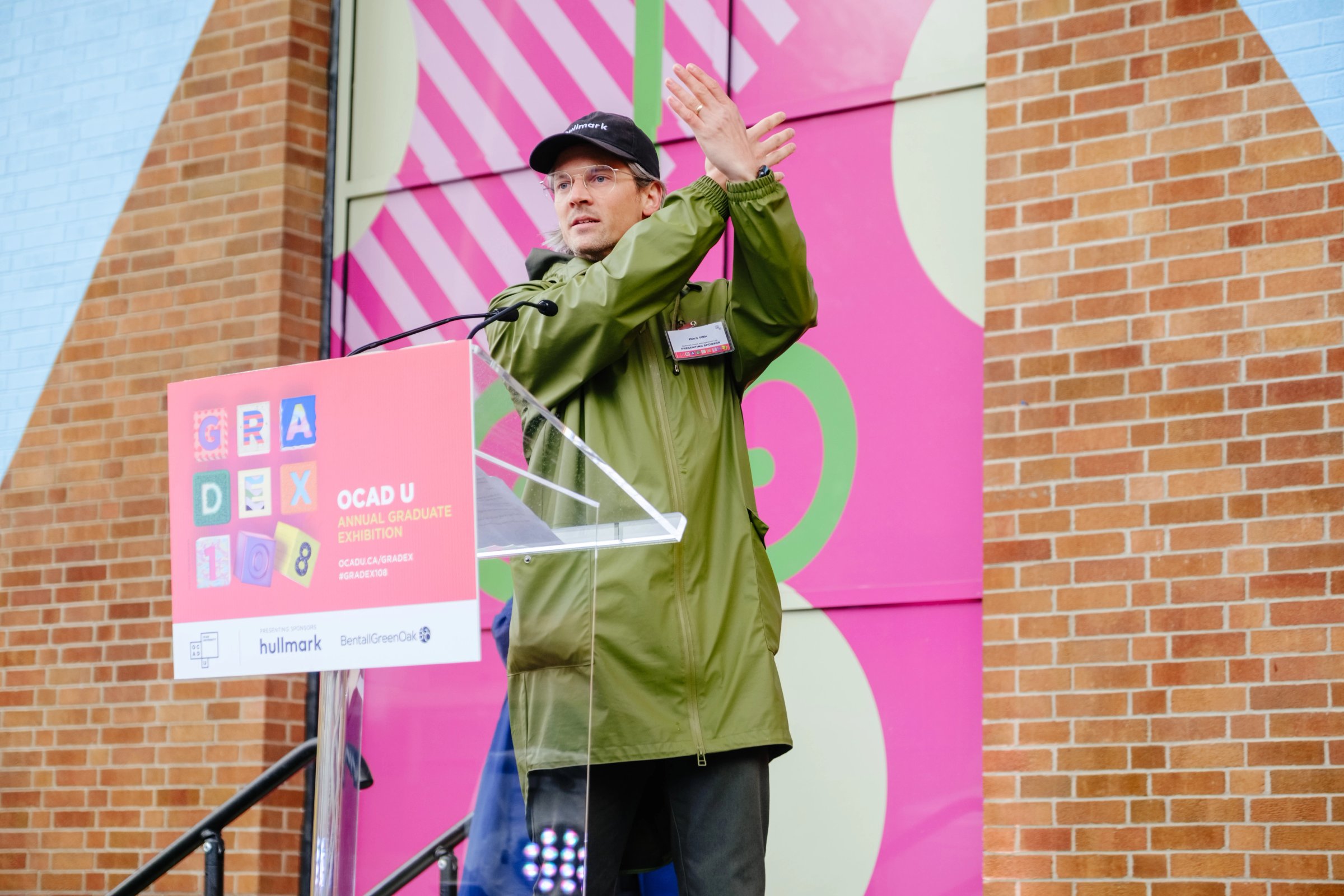 A person speaking at an outdoor podium