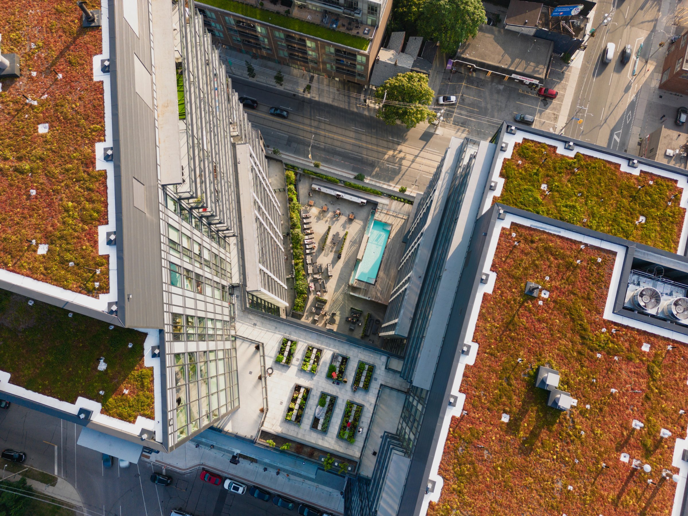 Aerial down-view of green roofs and a pool