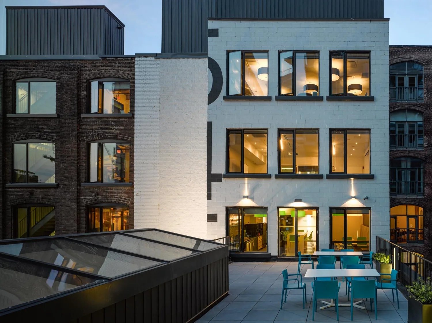 Lit brick courtyard with patio seating