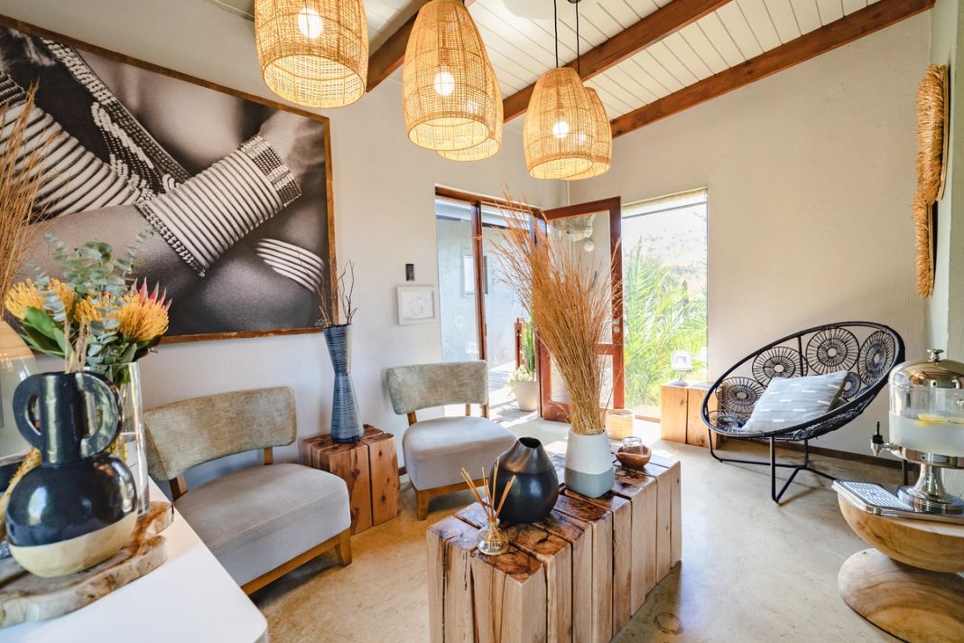 The spa relaxation room has a beaded-artwork wall, woven pendant lights and lounge chairs.
