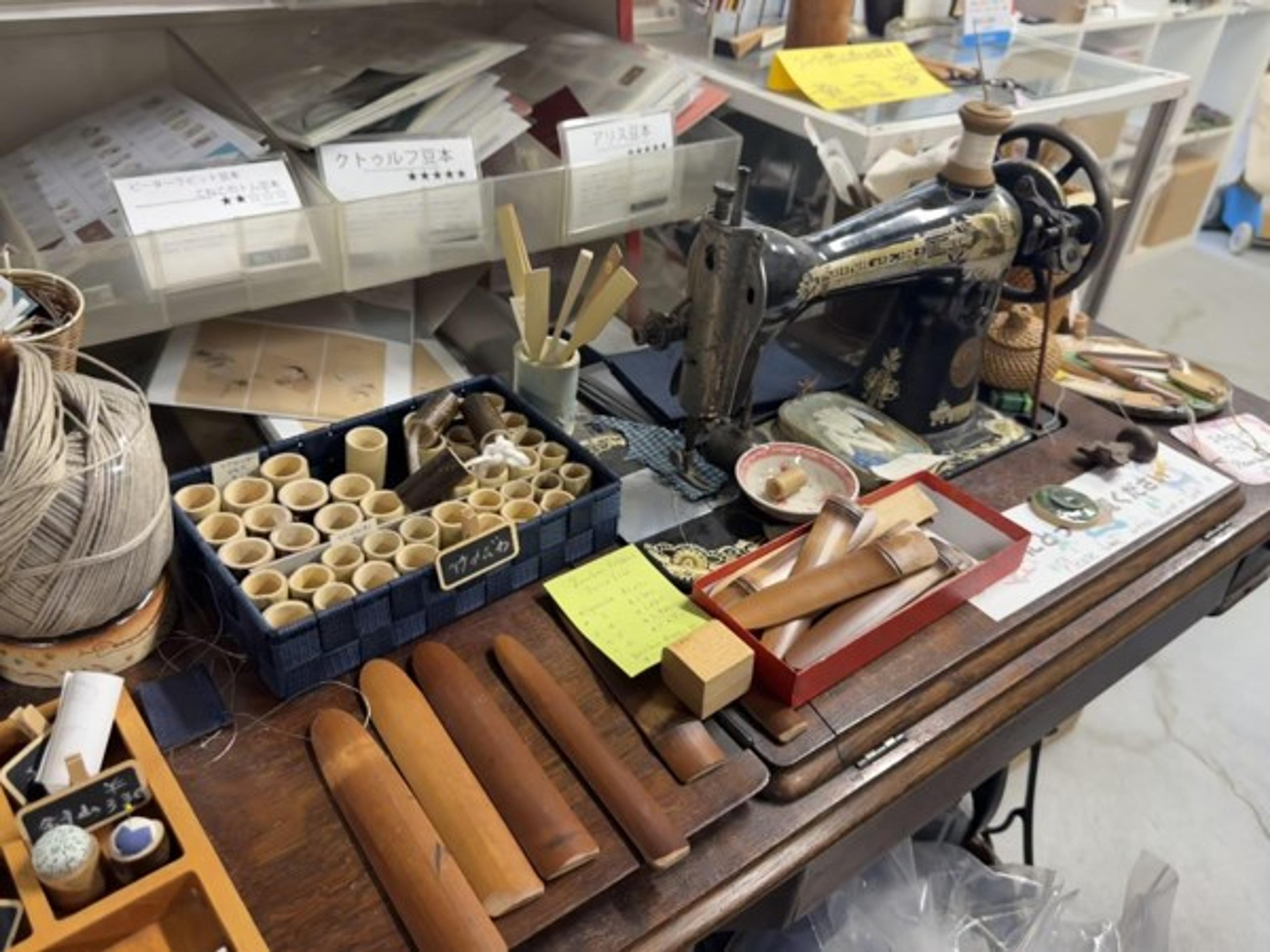 Hand tools, type and finishing materials on a working bench at Marumizu-Gumi