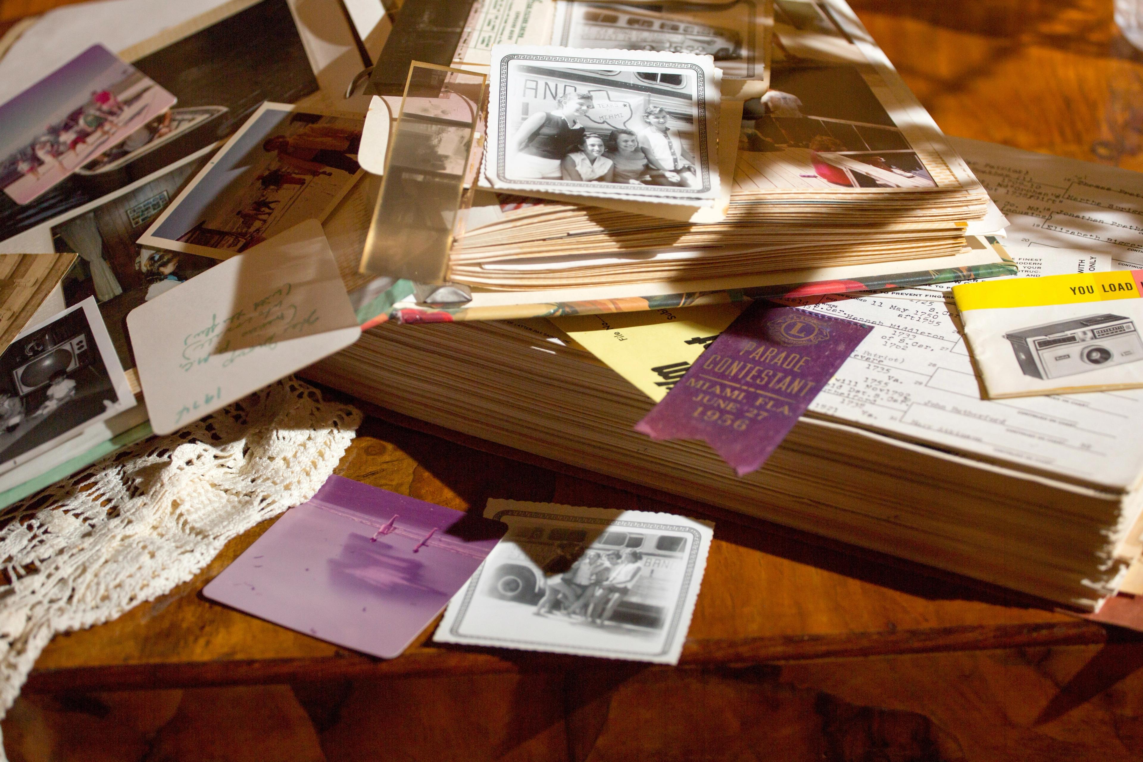 Someone compiling a memoir with photos and books