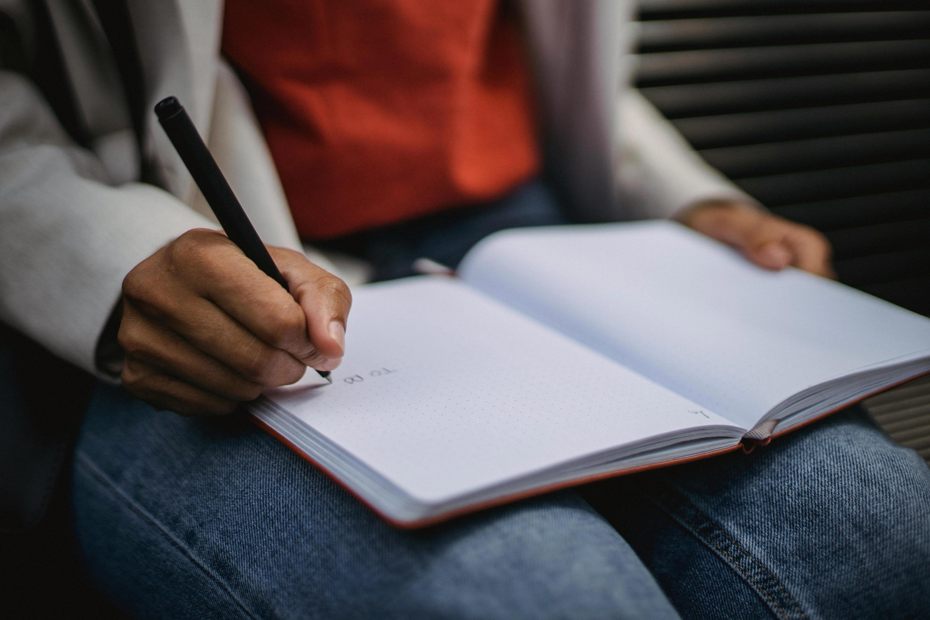 An open notepad on someone's lap
