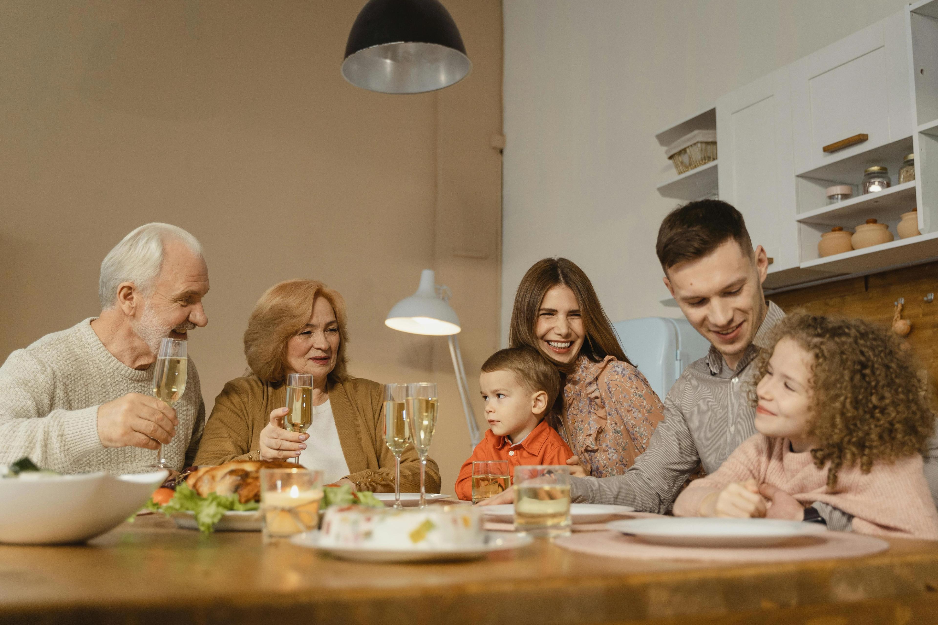 A family sat around a table sharing memories
