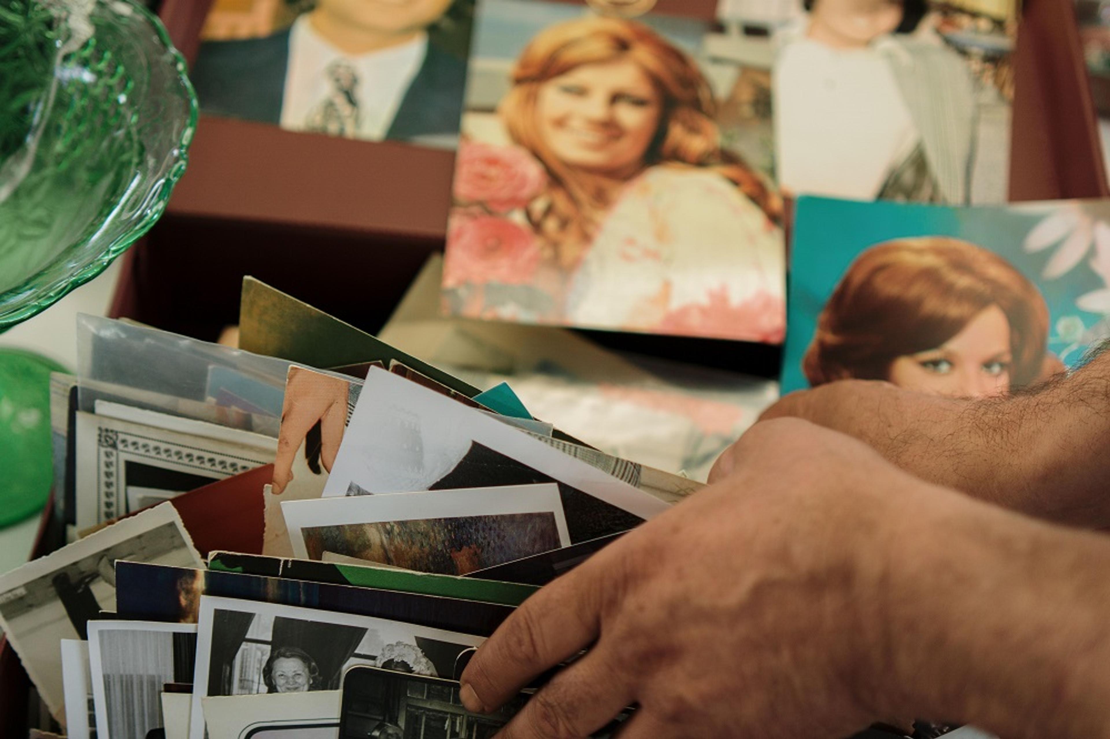 Hands sorting through old family photos