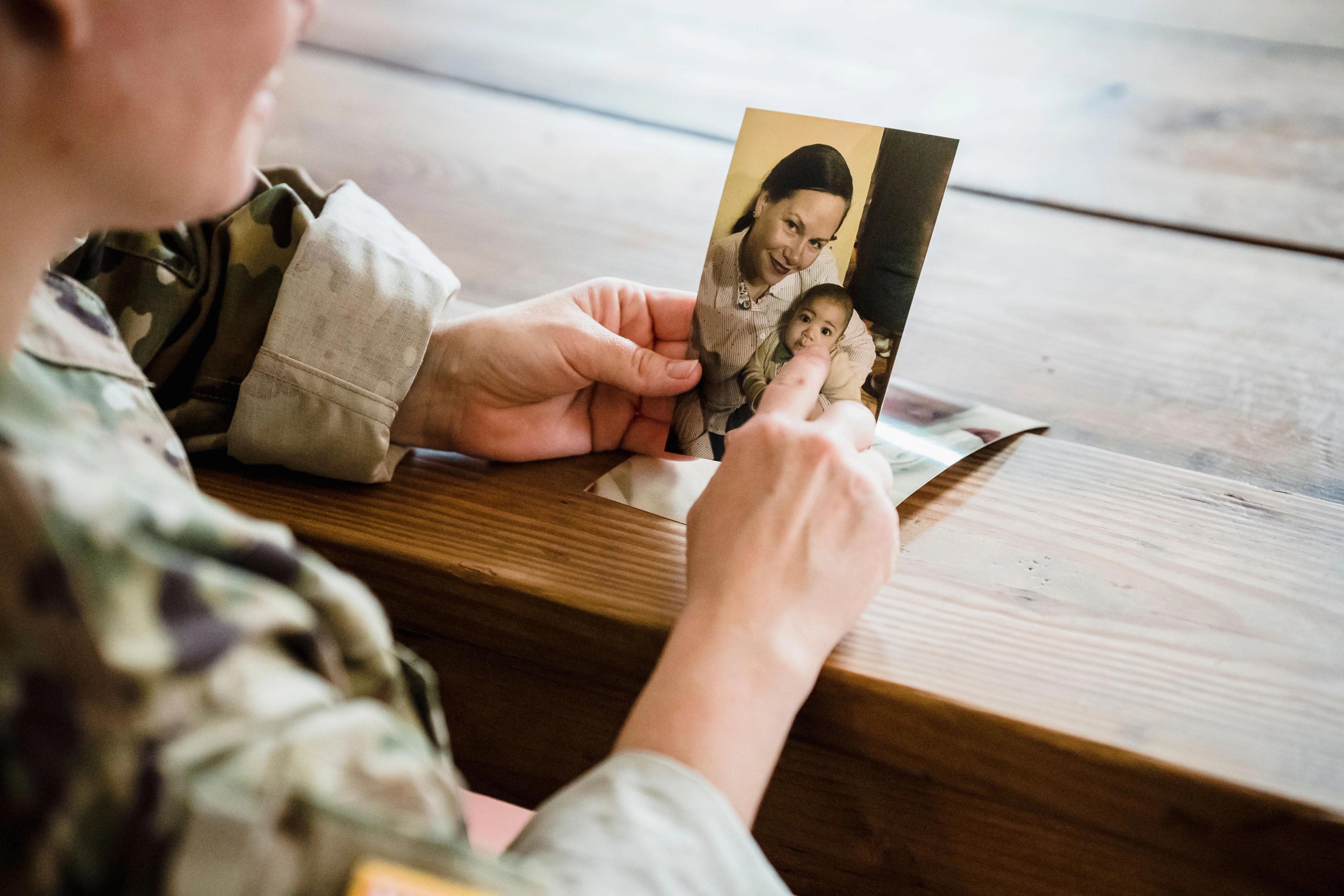 Person pointing at family photo