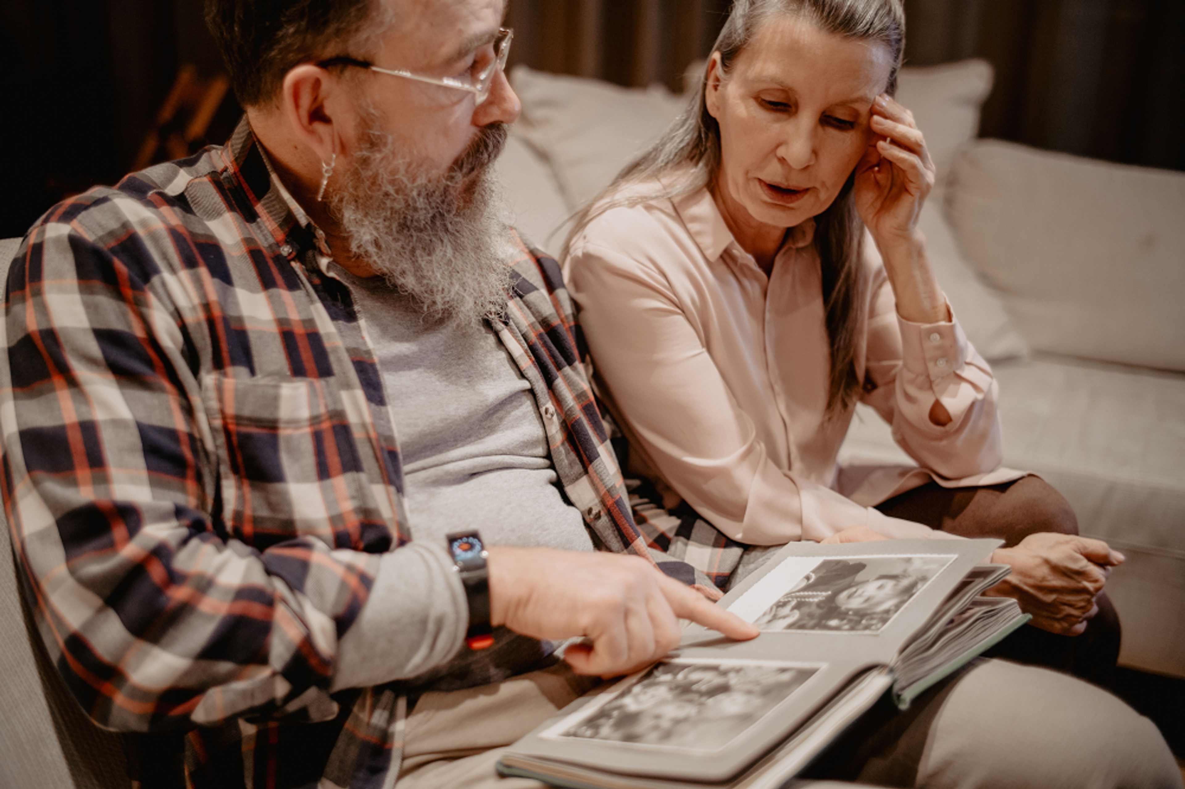 a man and a woman looking through old family photos