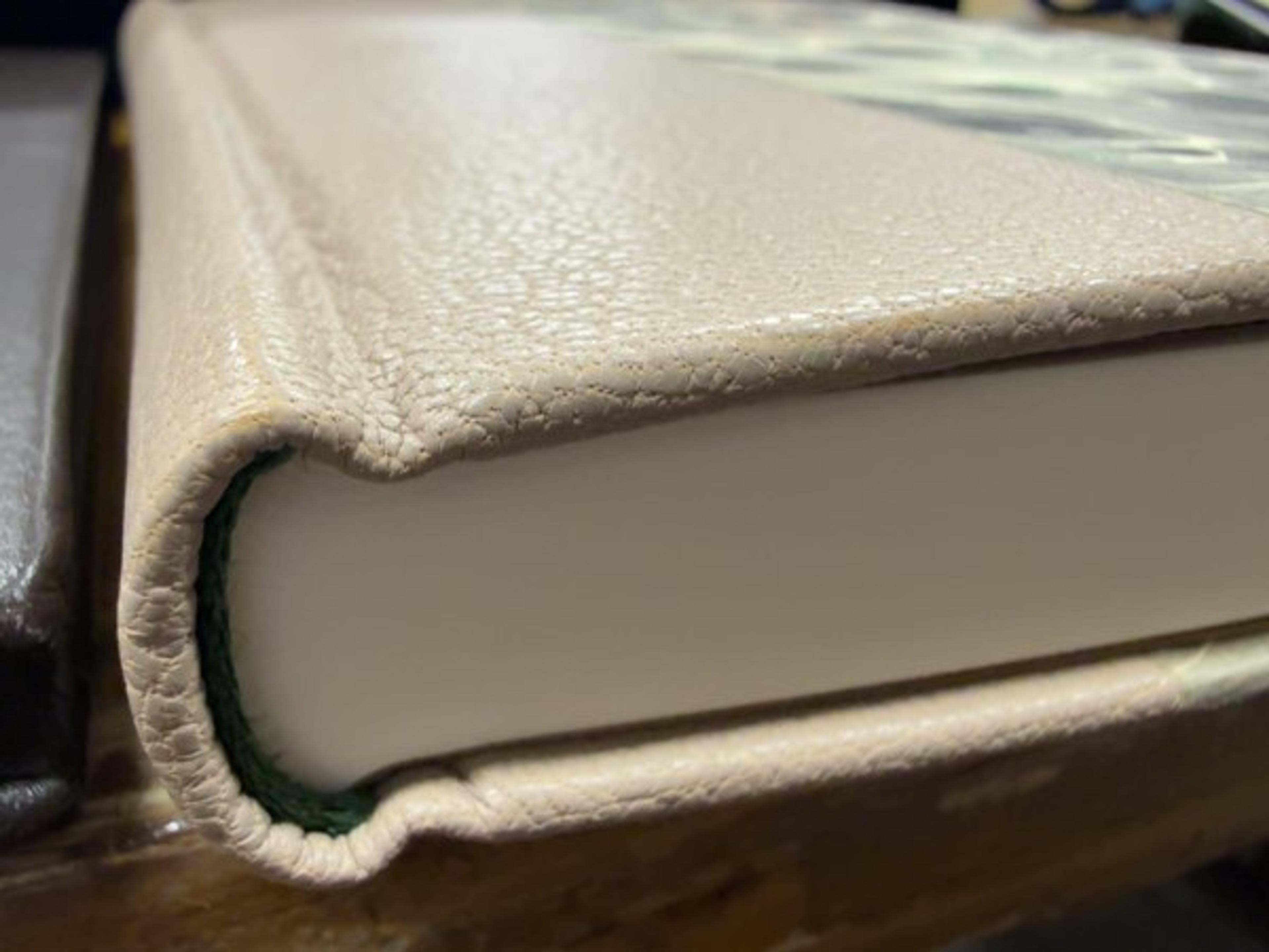 Rounded and carefully formed spine details are visible even when the book is closed