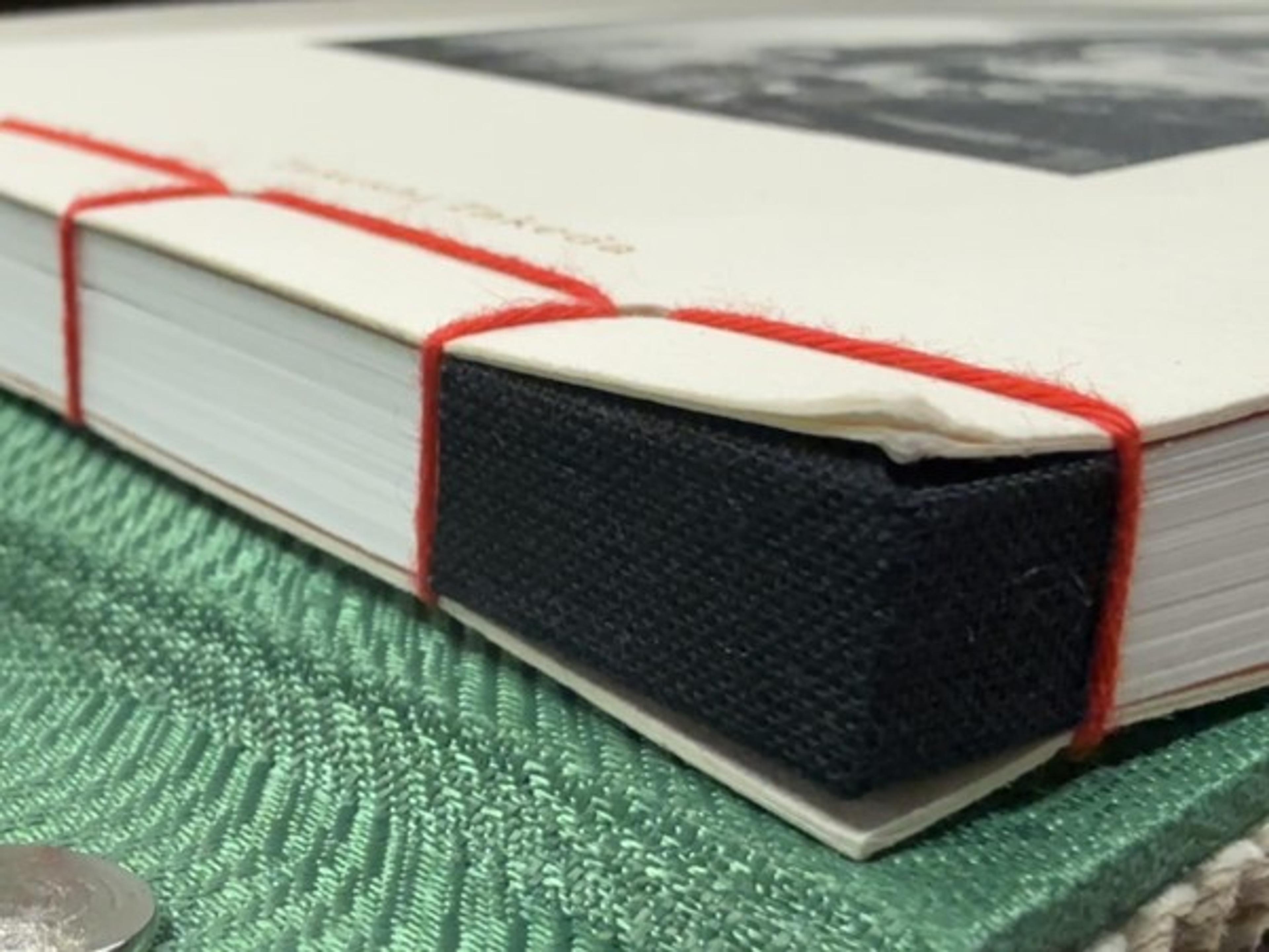 Visible red thread forms part of the design in this Japanese-style stab binding.