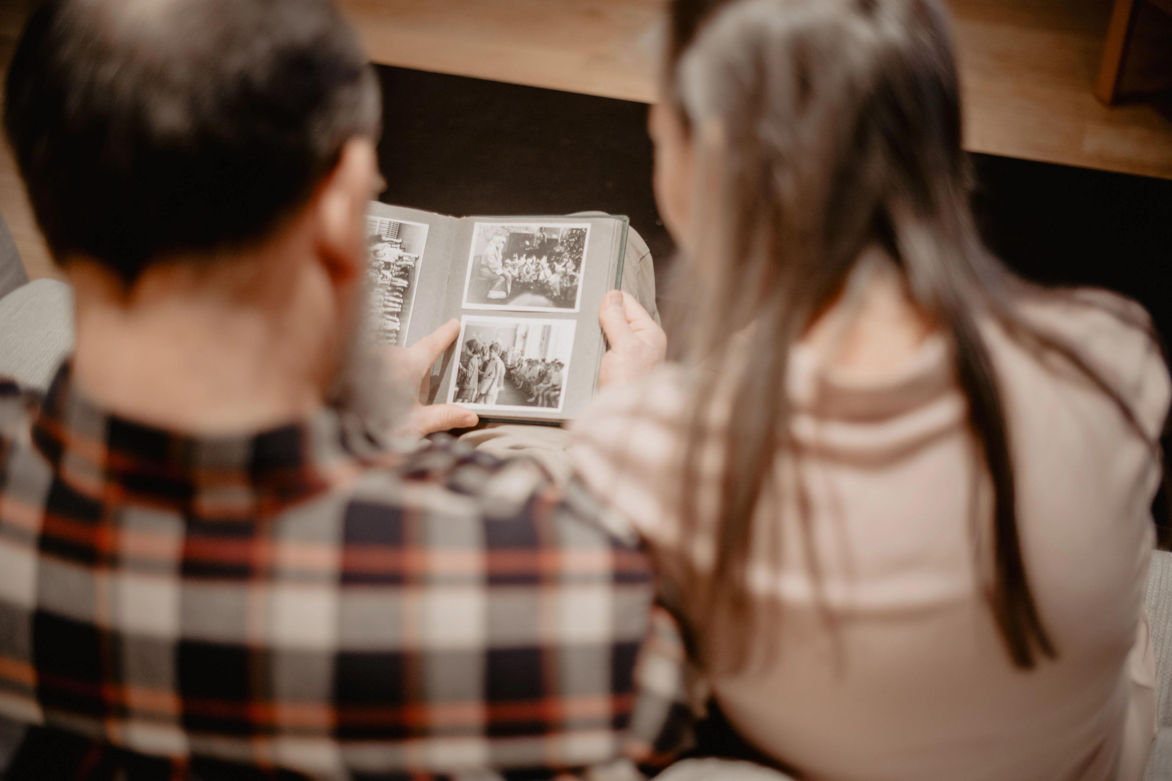 Two people looking at old photos