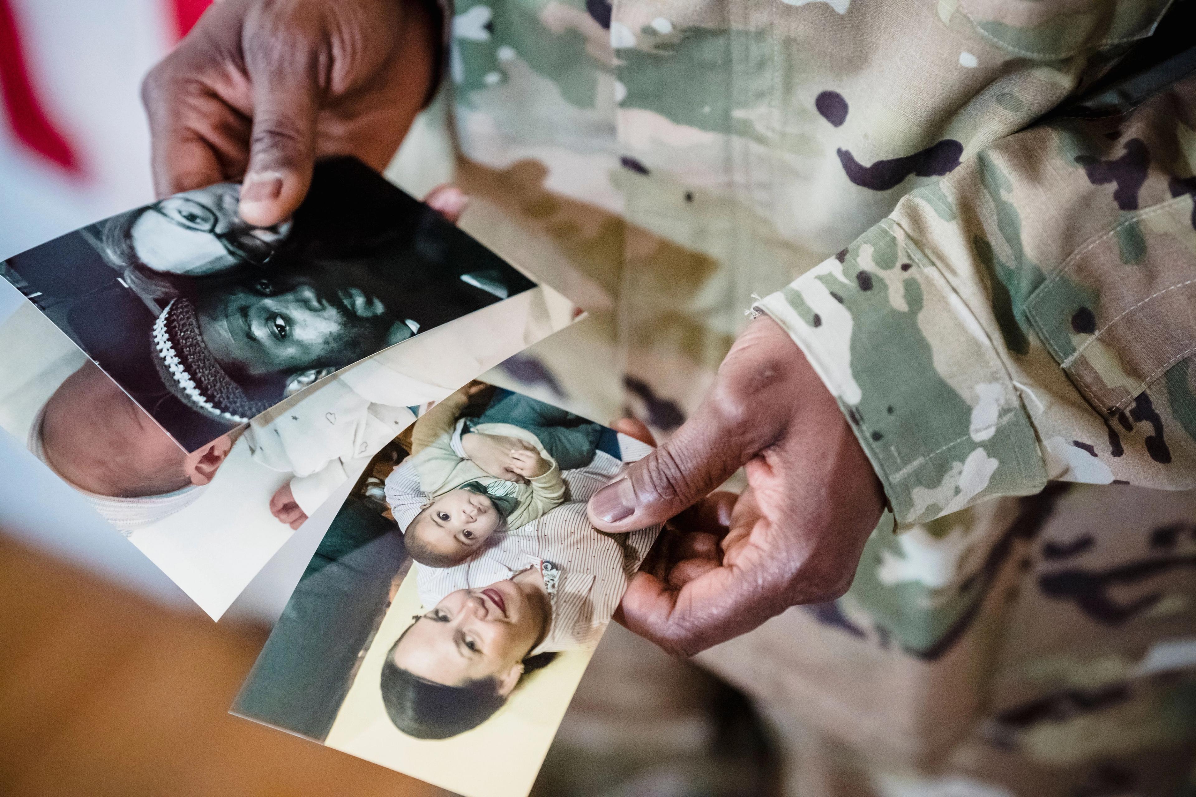 Military person looking at old photos