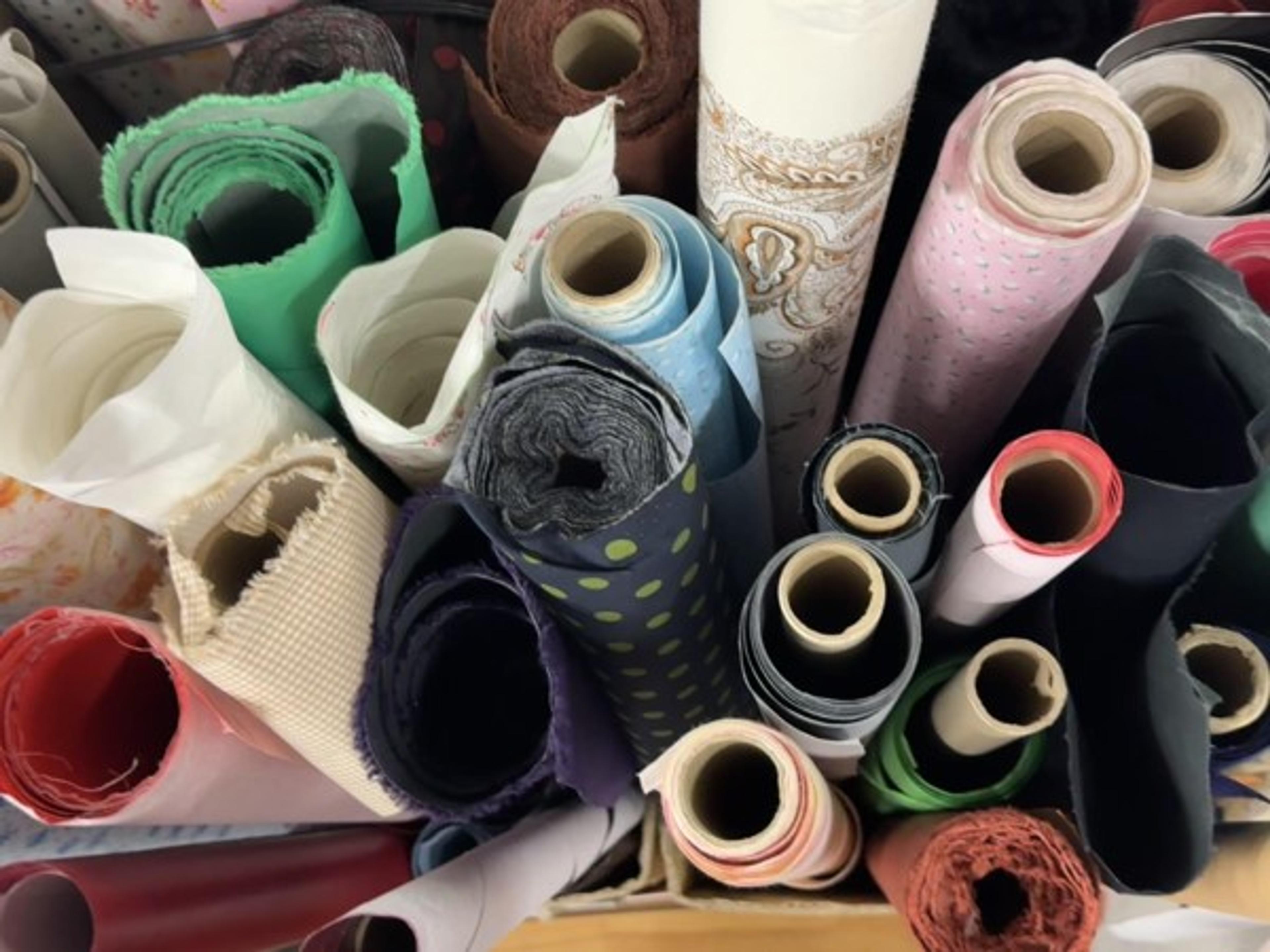 Rolls of solid and patterned cover materials at Marumizu-Gumi.