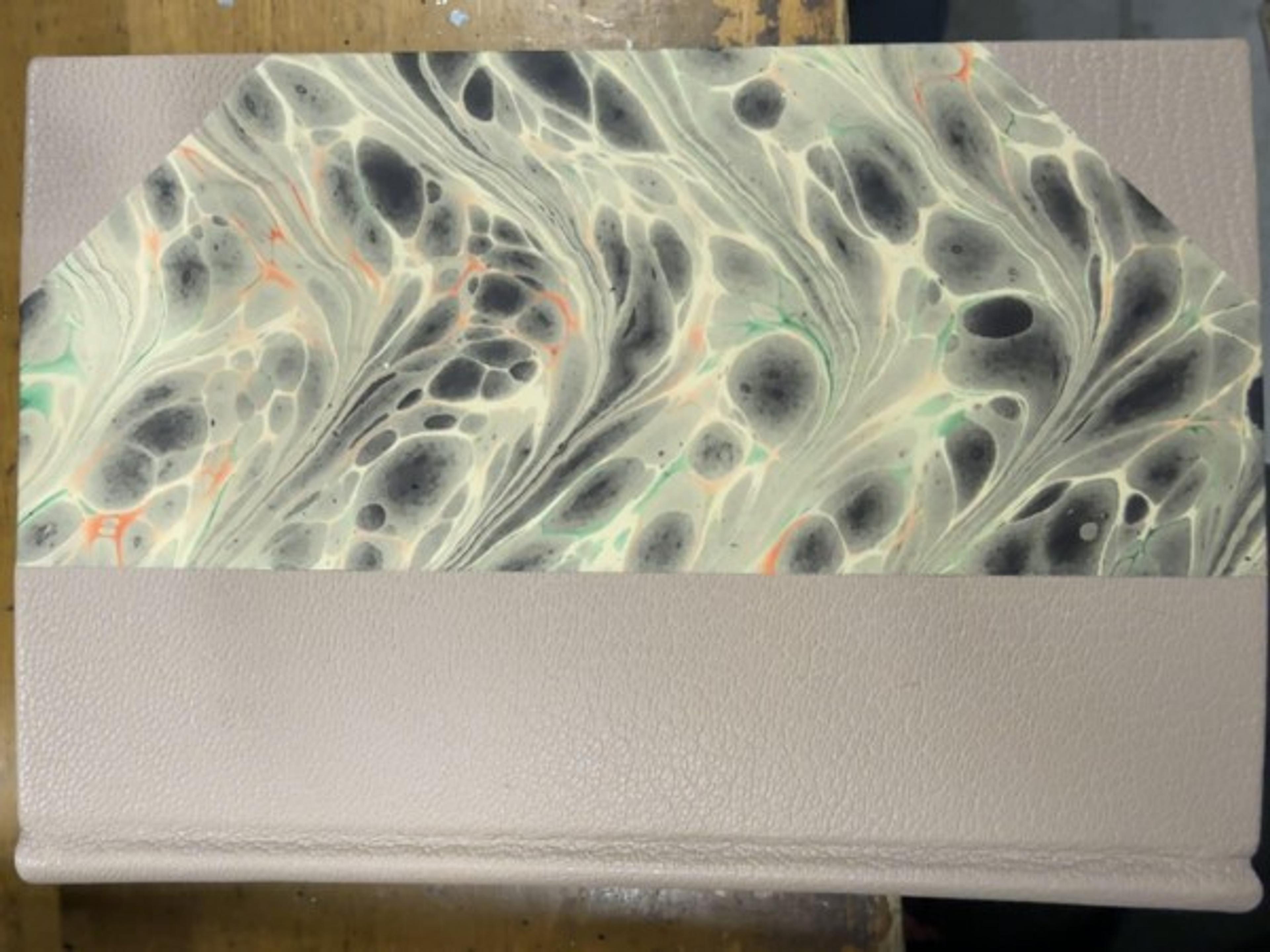A marbled-paper panel can introduce pattern without covering the entire book