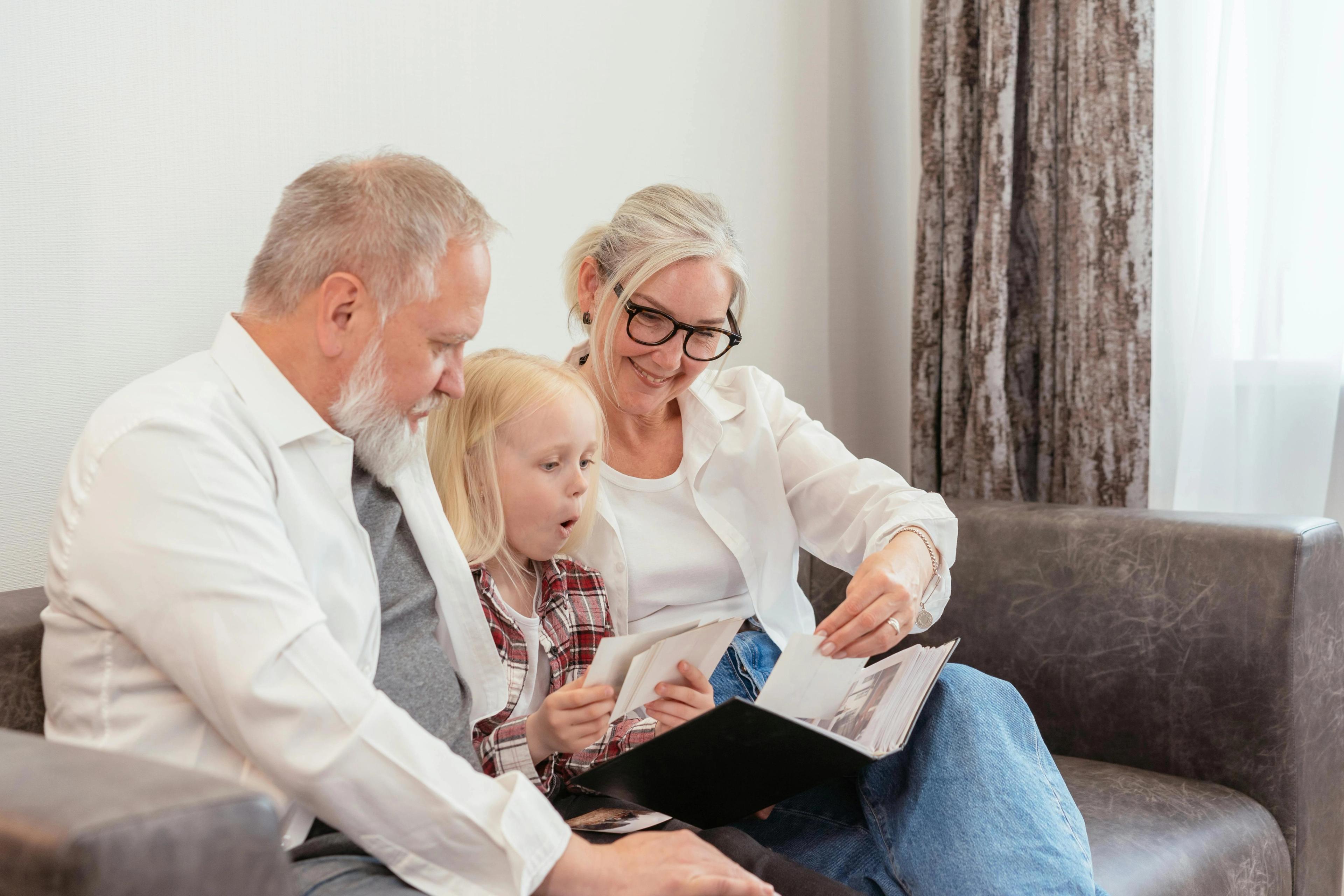 Grandparents and a child looking at a book