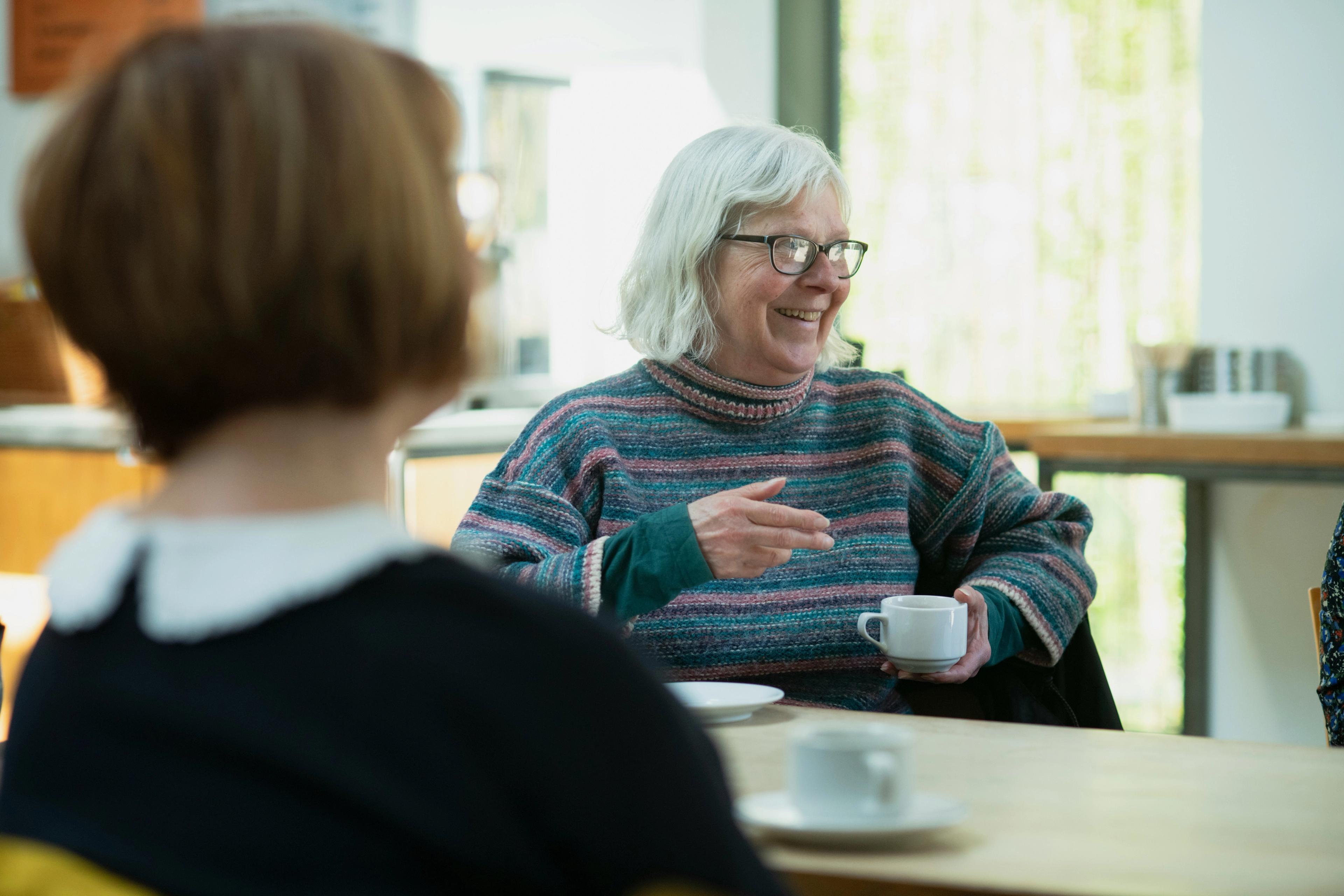 A woman having a cup of coffee