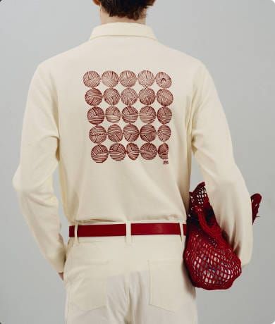 Back of a HEAD Golf cream long-sleeve polo printed with a grid of red wound-ball graphics