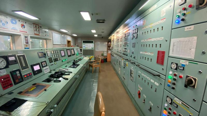 A control room densely packed with instrument panels, gauges, and electronic monitoring equipment.
