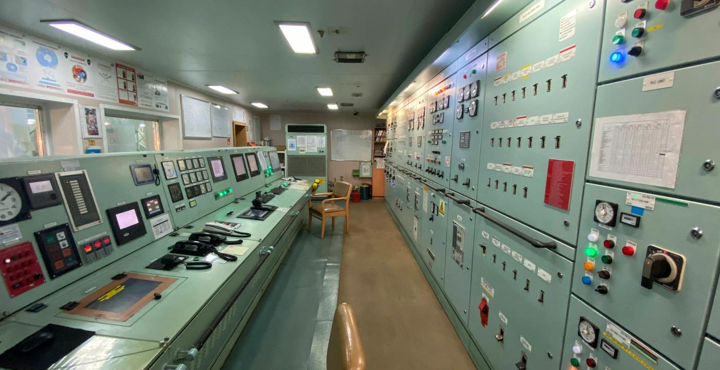 A control room densely packed with instrument panels, gauges, and electronic monitoring equipment.