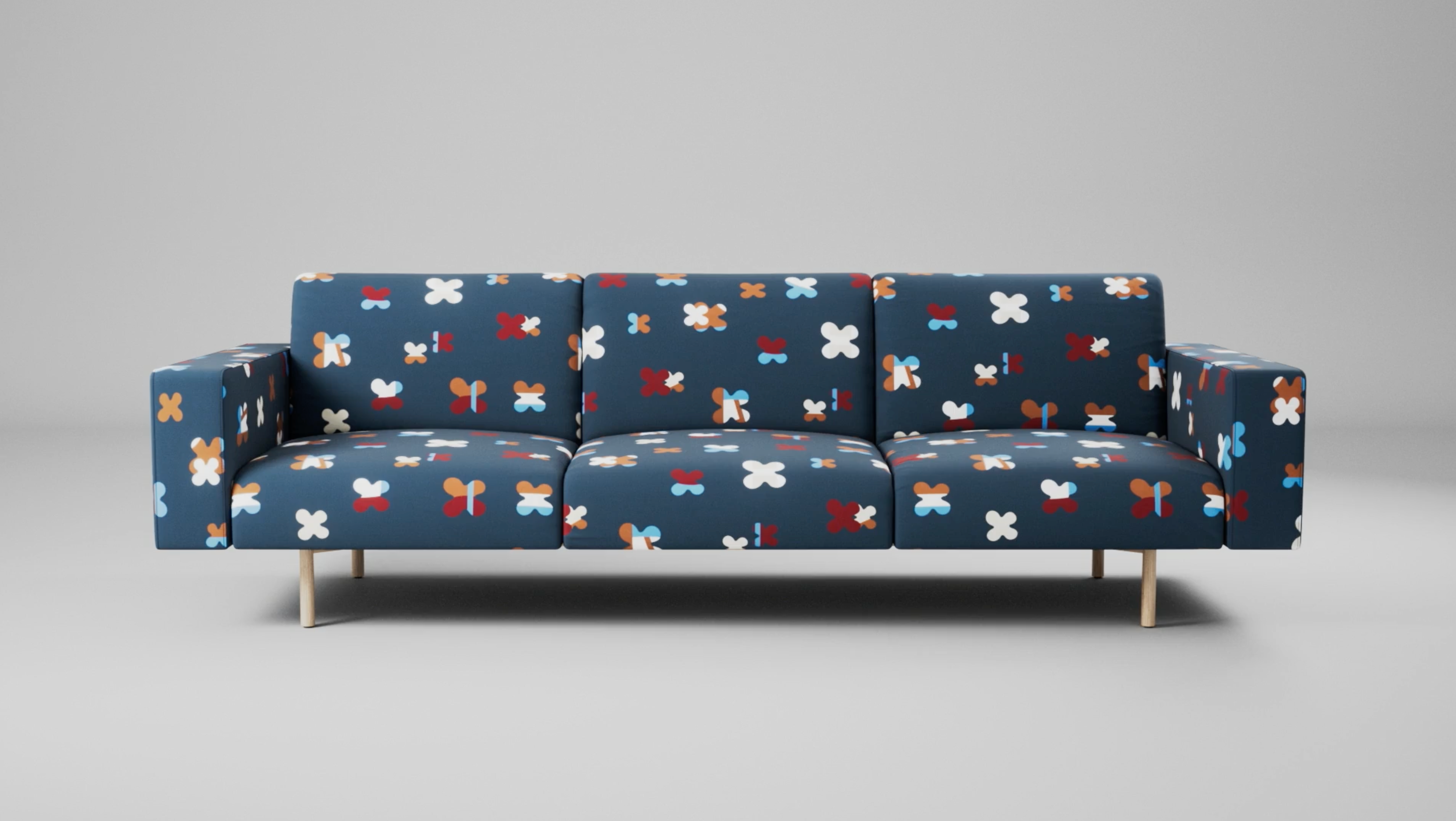 A sofa upholstered in Designtex's Champ pattern textile against a gray studio backdrop