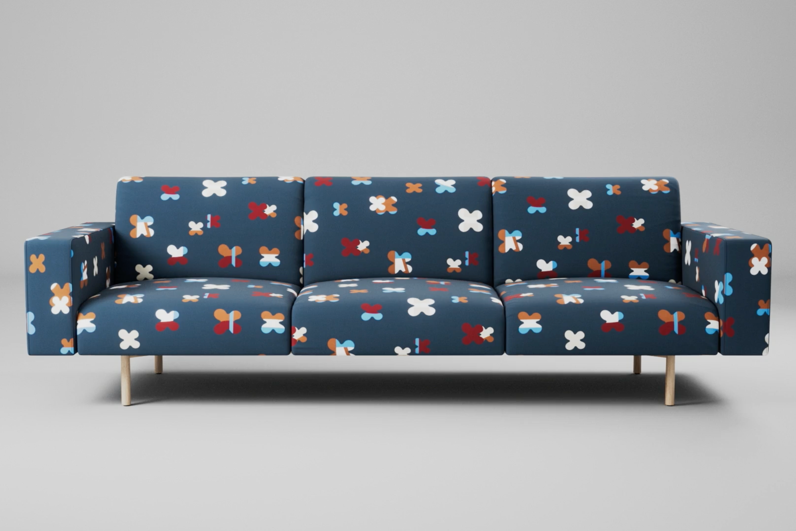A sofa upholstered in Designtex's Champ pattern textile against a gray studio backdrop