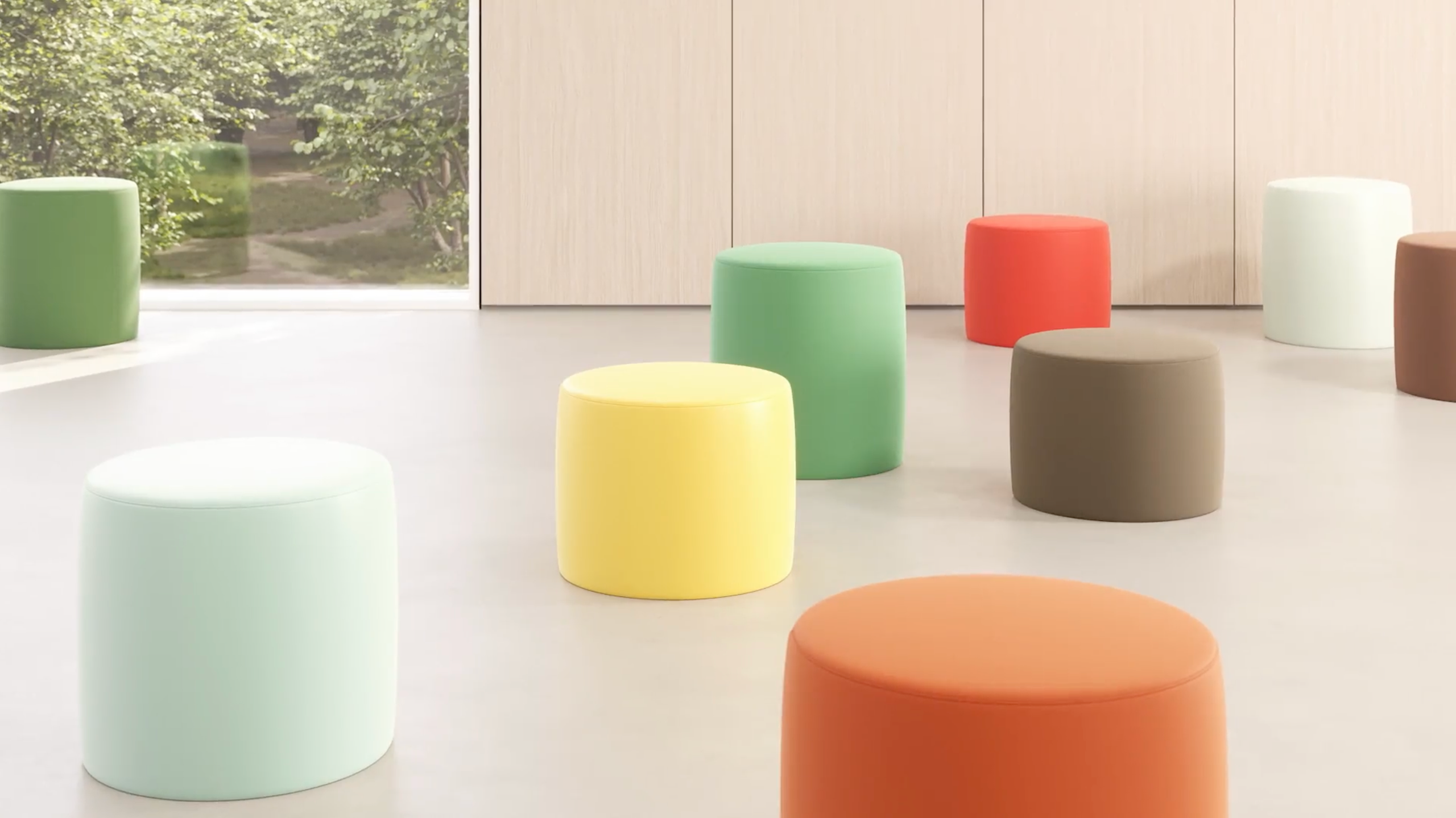 Colorful upholstered stools in Designtex textiles in a bright, wood-paneled interior