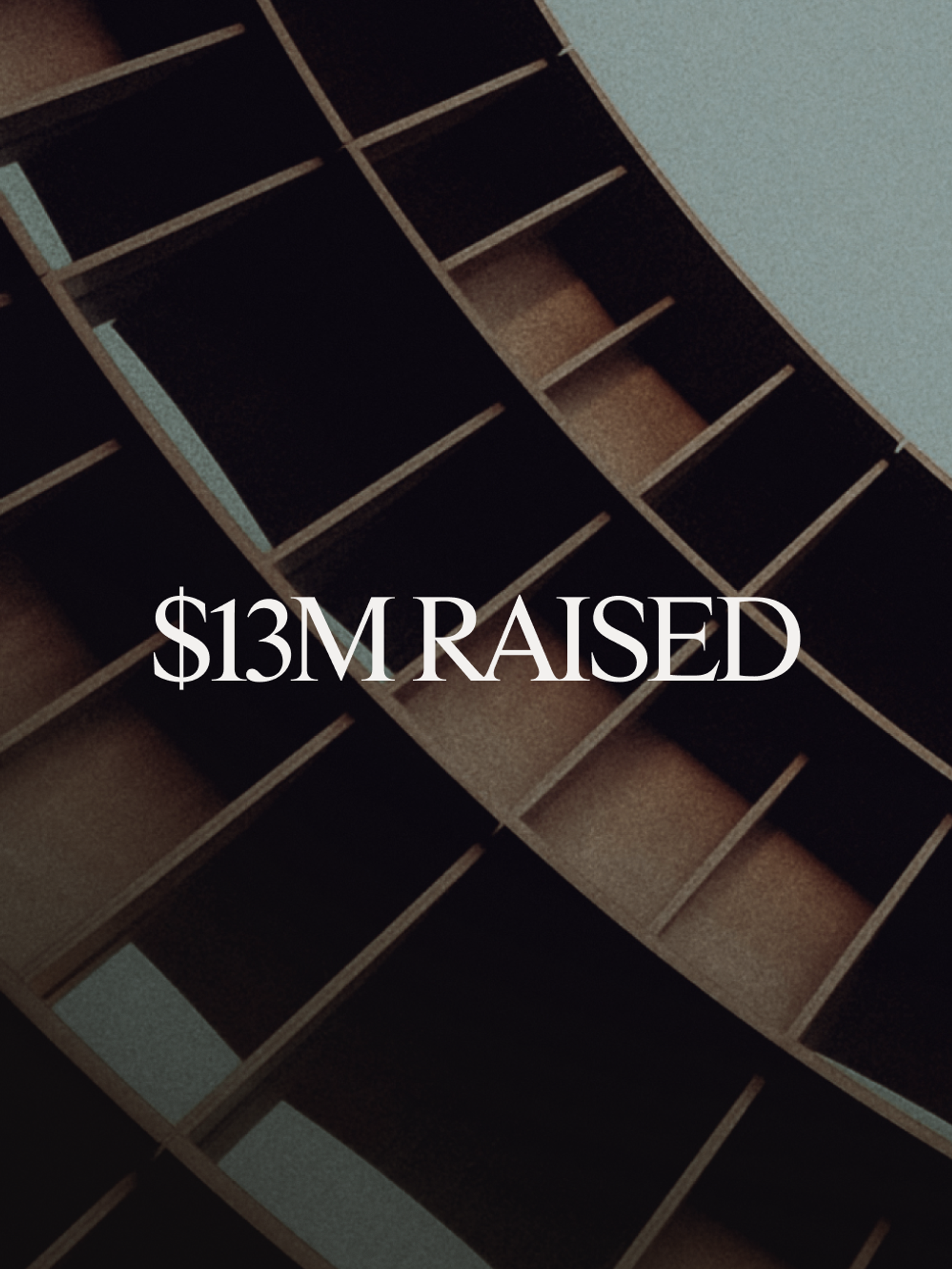 The text "$13M RAISED" over a dark, angled wooden grid.