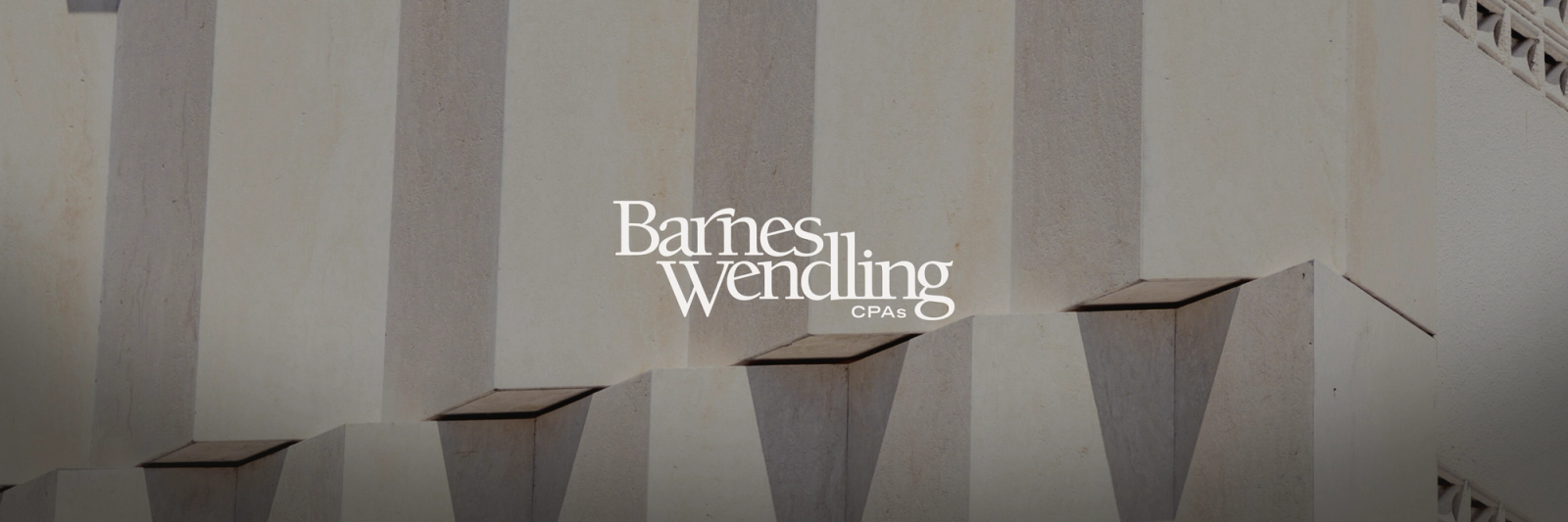 Barnes Wendling CPAs logo over a light-colored, textured building facade.
