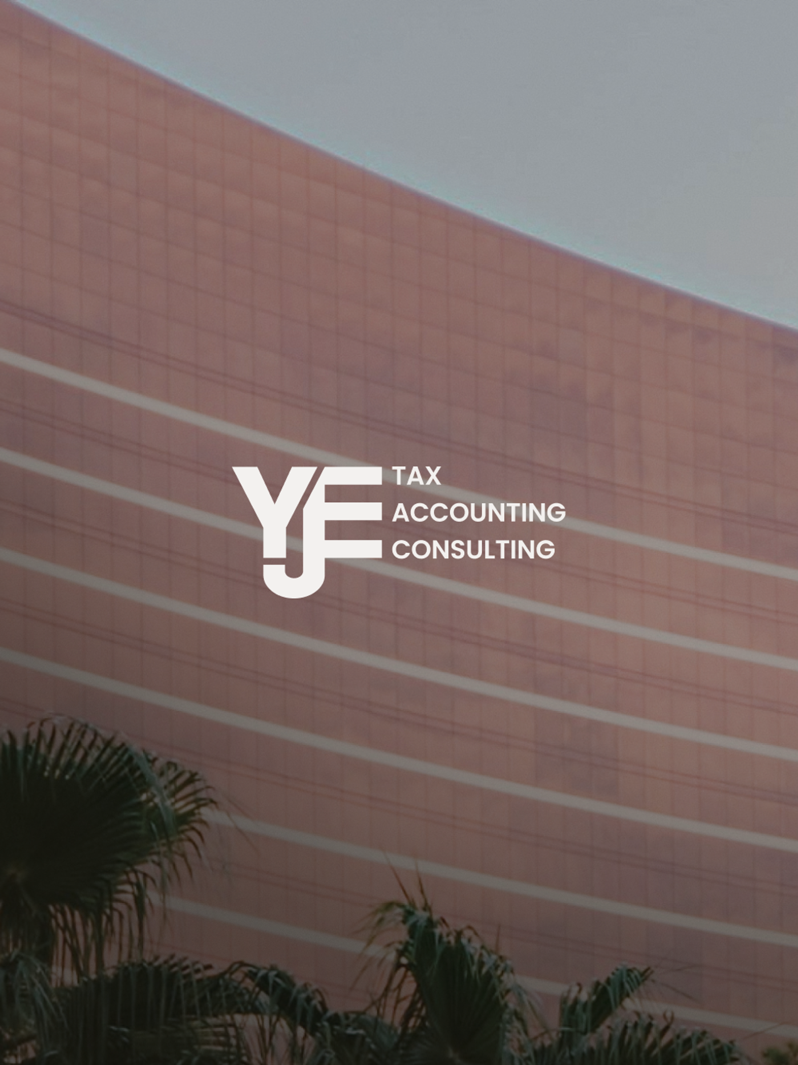 White YJE Tax Accounting Consulting logo over a building with palm trees.