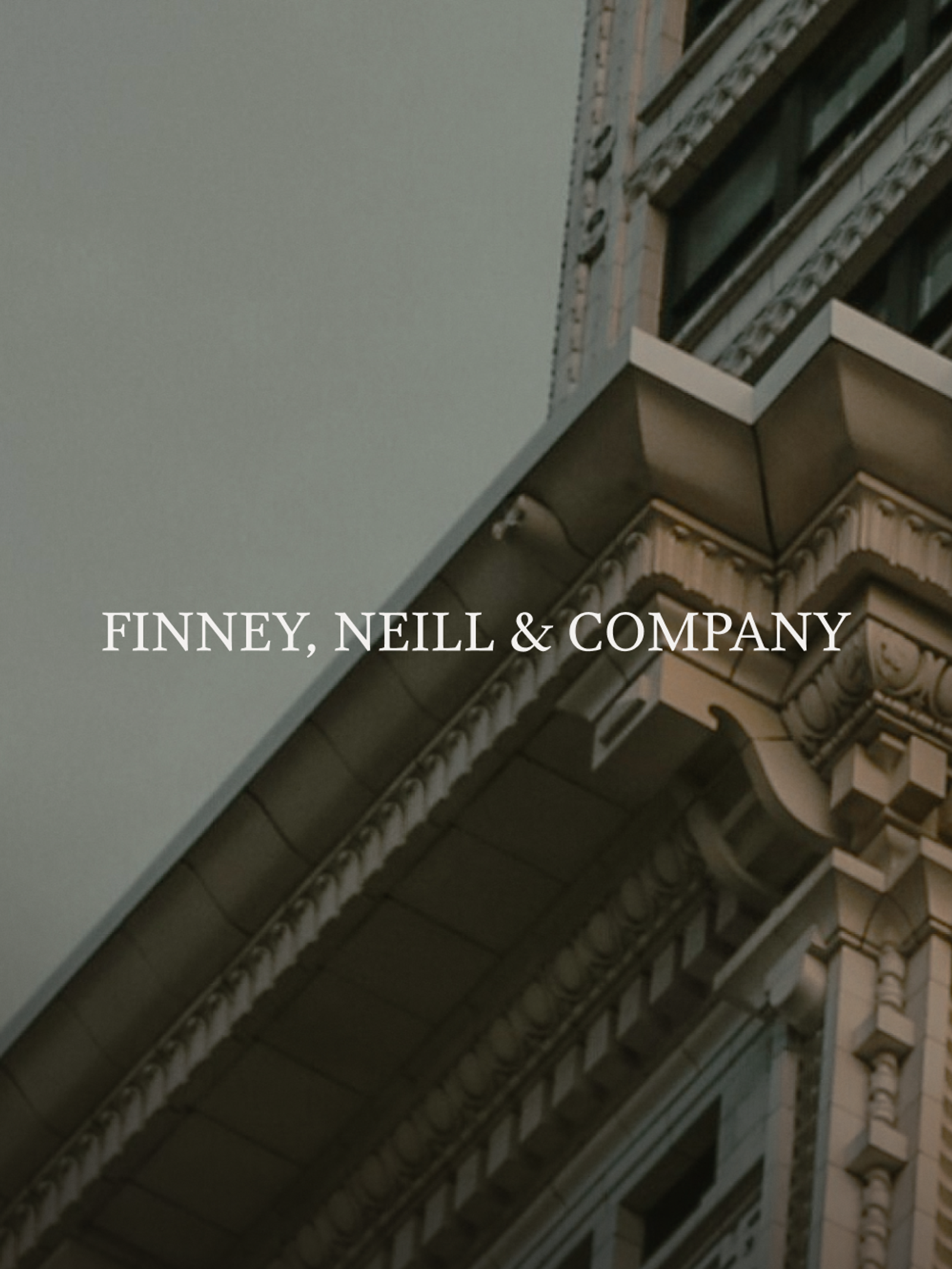 "FINNEY, NEILL & COMPANY" text over an ornate building facade against a grey sky.