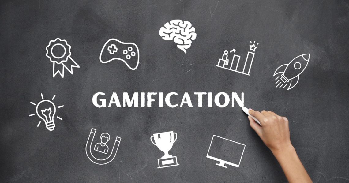 Gamification mind map on chalkboard with graphics indicating learning milestones and rewards.